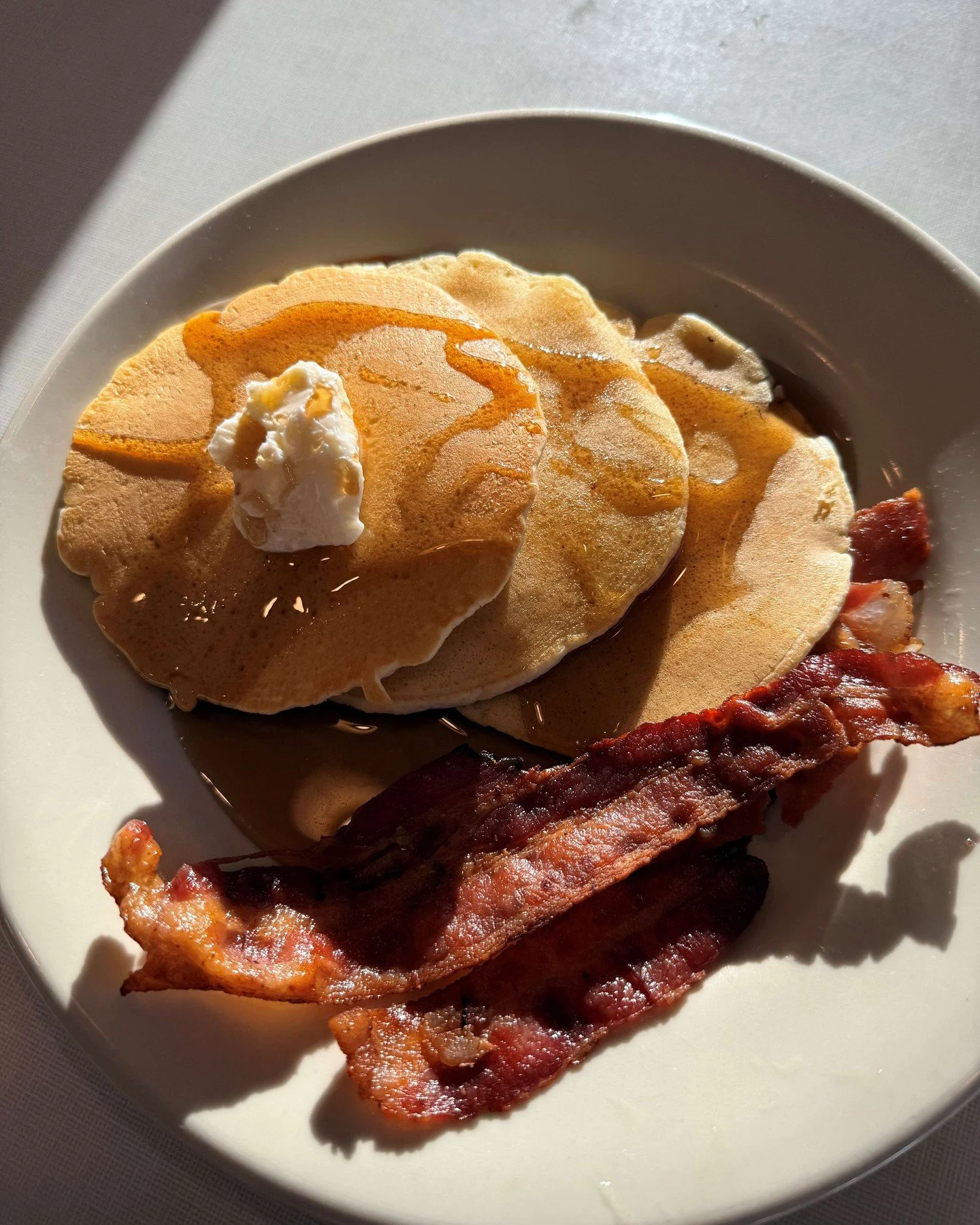 Have you tried this month&rsquo;s breakfast special yet? 🥞 Three fluffy pancakes hot off the griddle with perfectly crispy bacon! It&rsquo;s the kind of breakfast that makes getting up early worth it. Available during breakfast hours all month long!