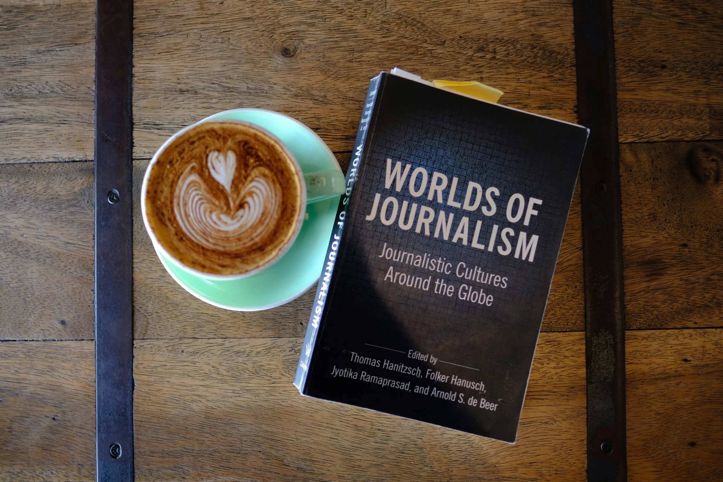 Journalism book and coffee, shot from above.