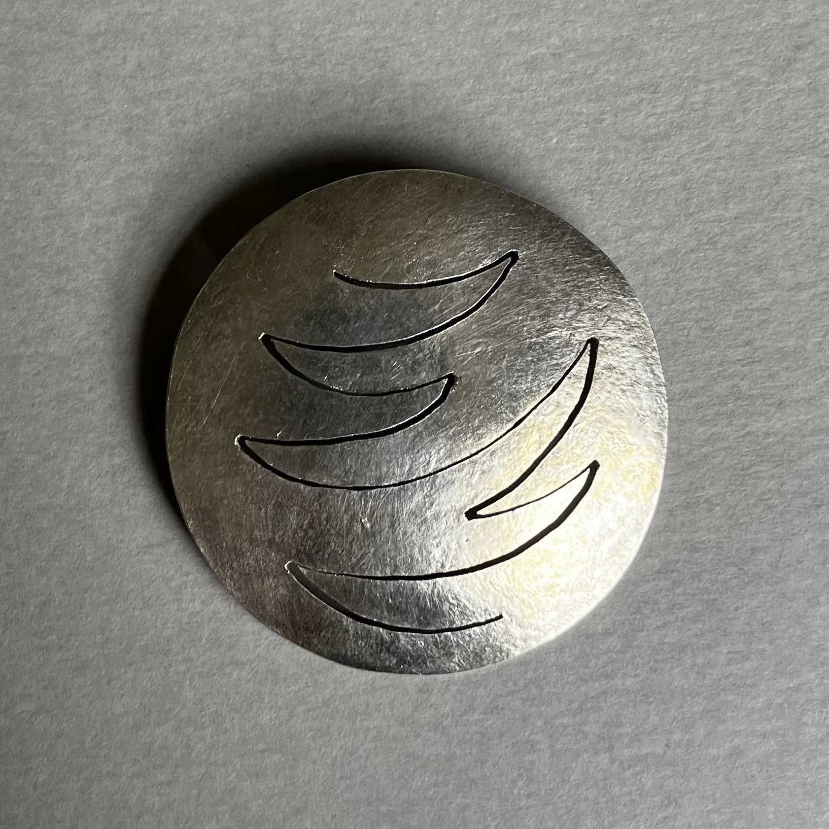 Saw-pierced silver brooch
