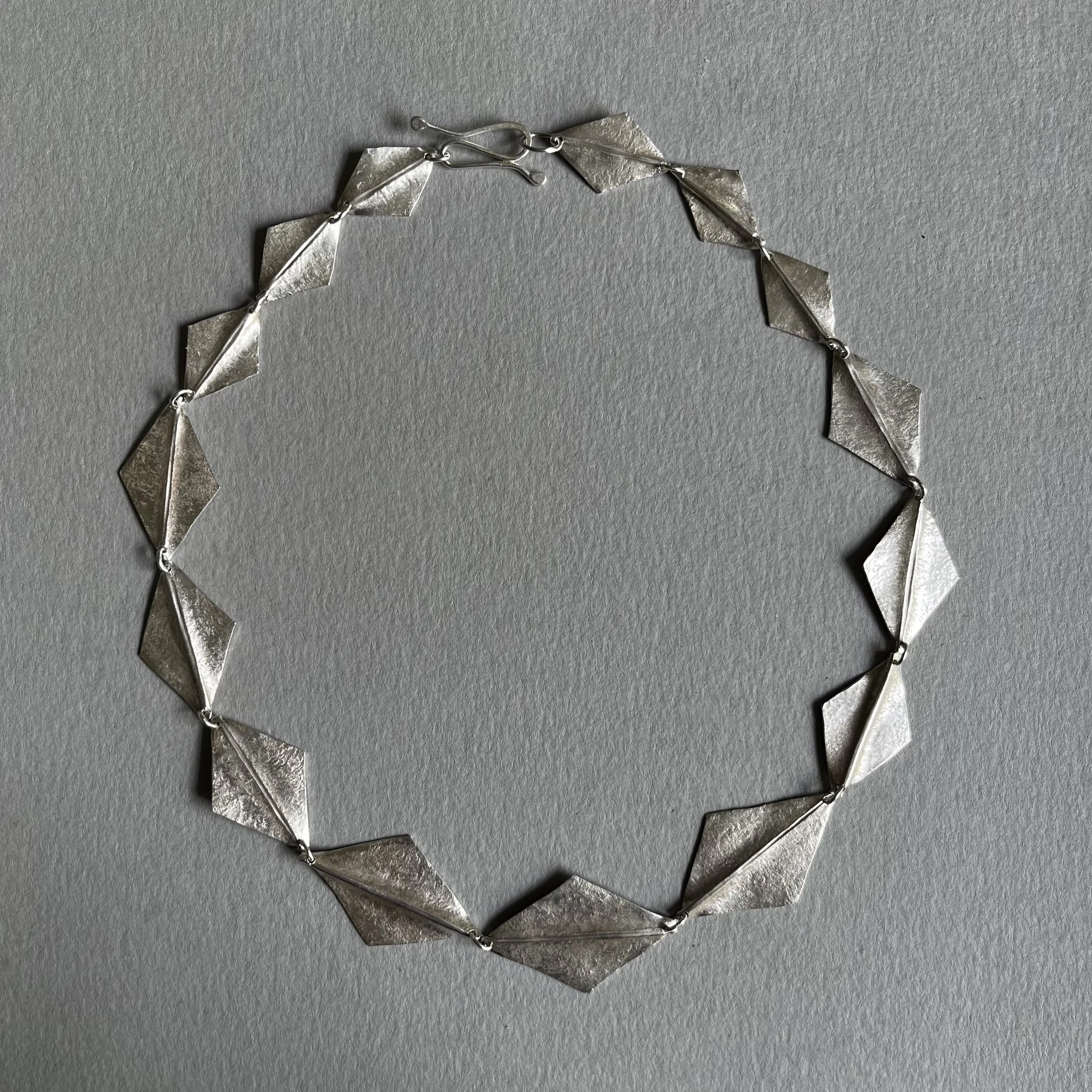Textured, folded silver