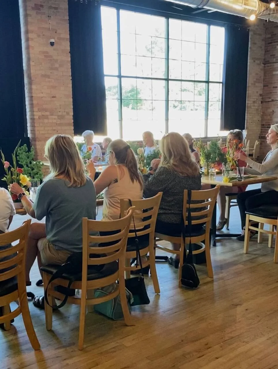 Guests observing flower demo at Duluth class