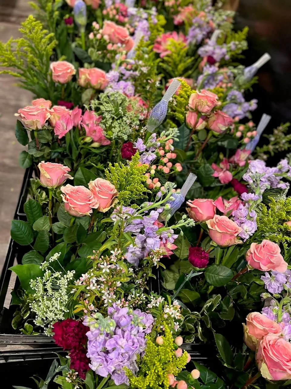 Buckets of flowers ready to be used at a flower workshop