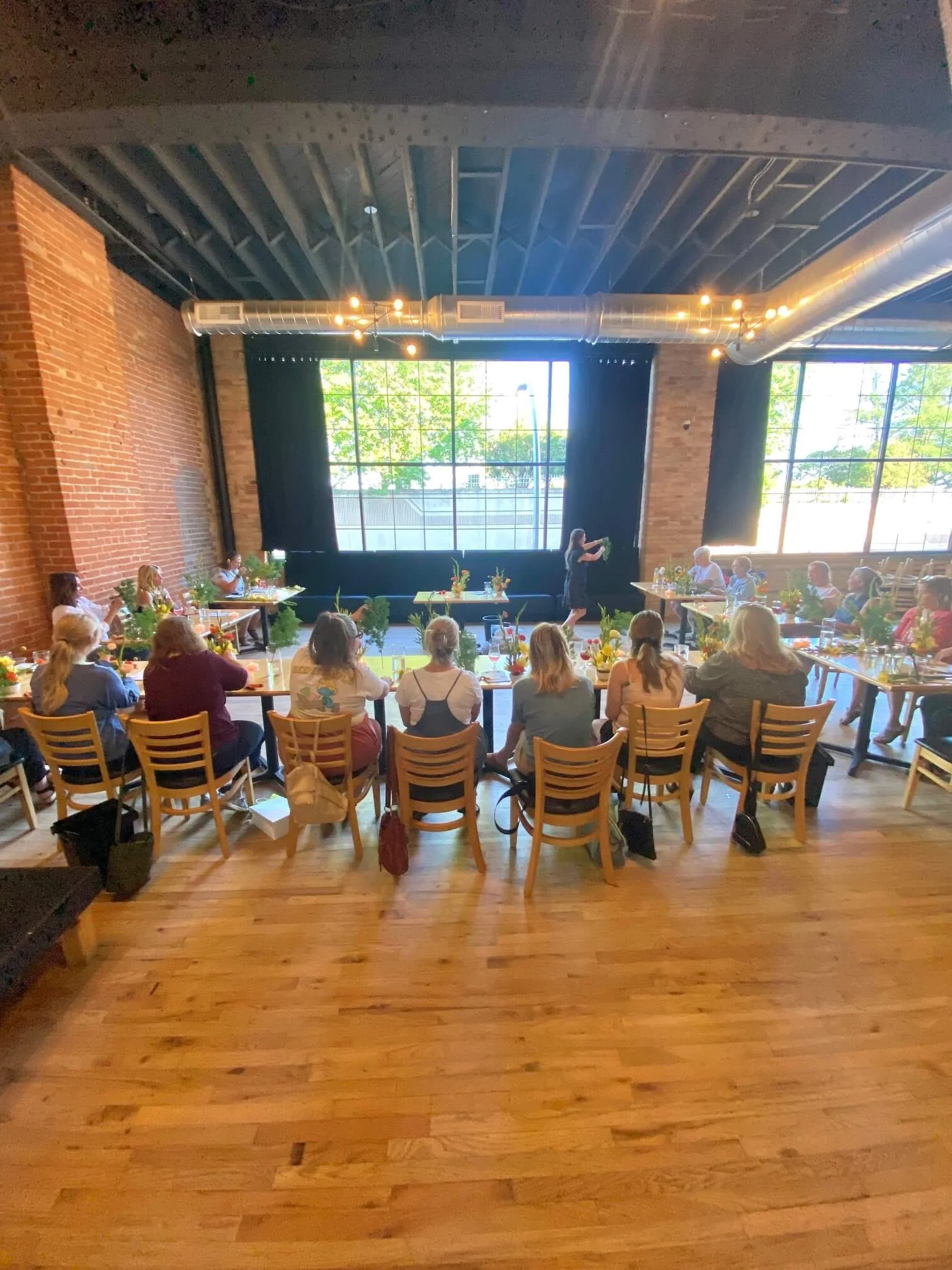 Duluth flower bouquet class demonstration behind class participants.