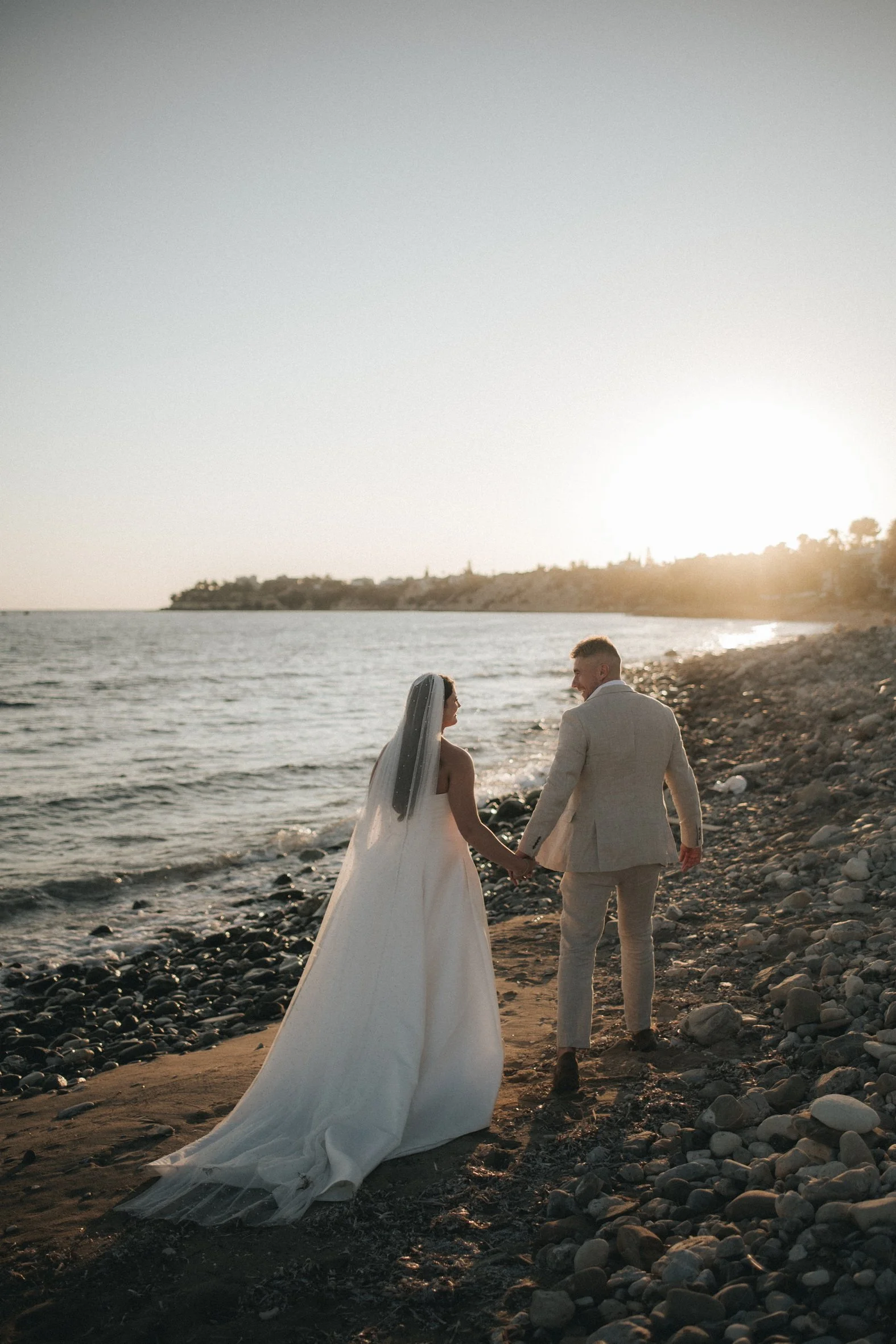 couple walking in the the sunset ont the beach in Cyprus