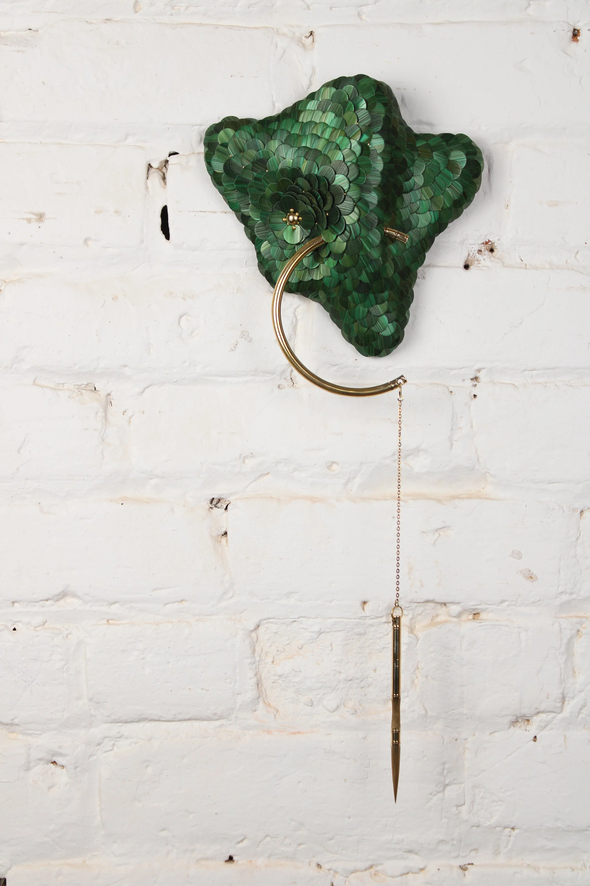 Contemporary small green and gold sculpture for wall named Invisible Monster 20, Teach series from the Amoebas Realm collection. Made with rye straw , brass and wood. Made by the artist Jonathän Jouan in 2026. 