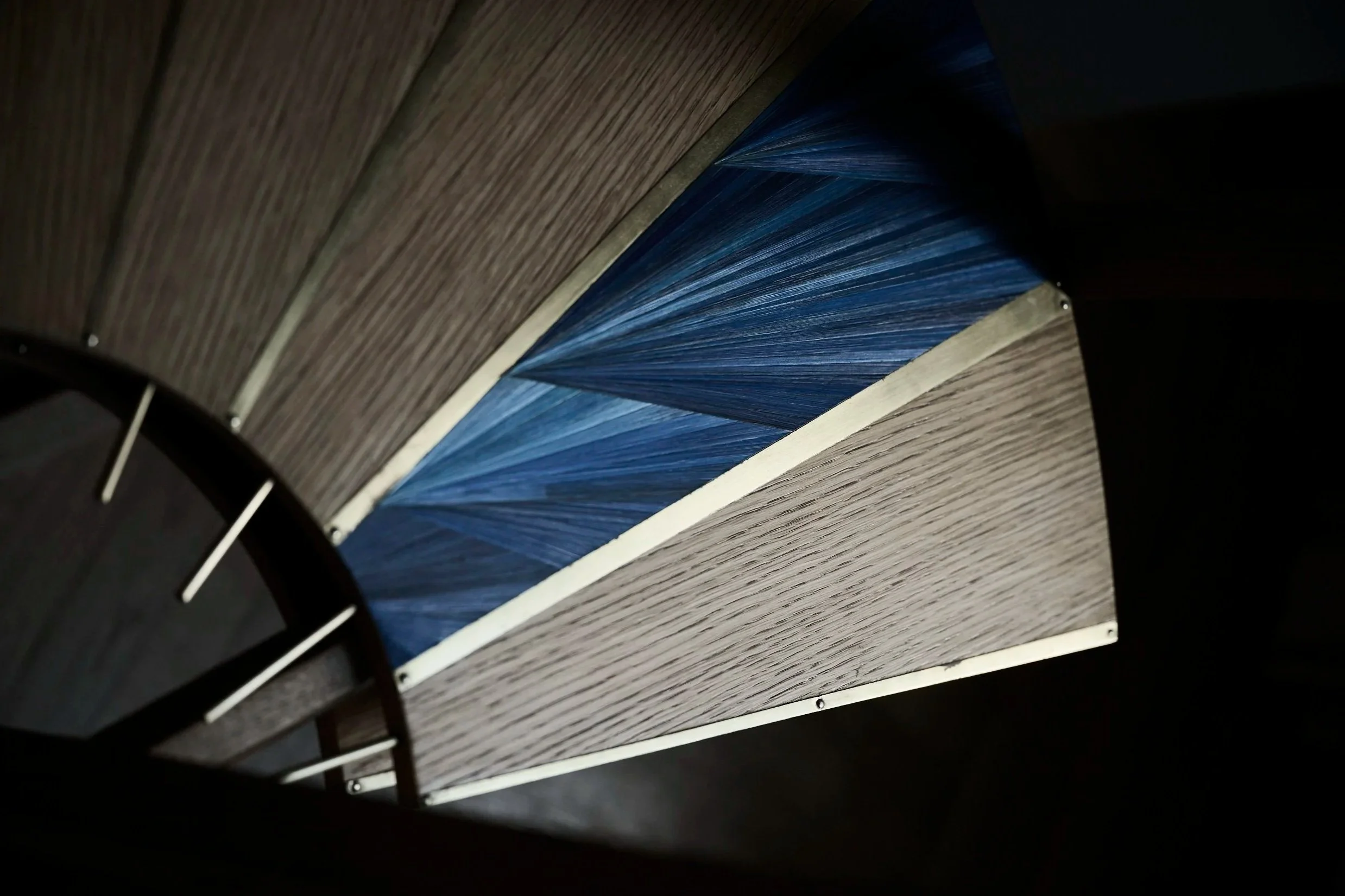 detail of a sculptural desk in straw marquetry and oak wood and brass