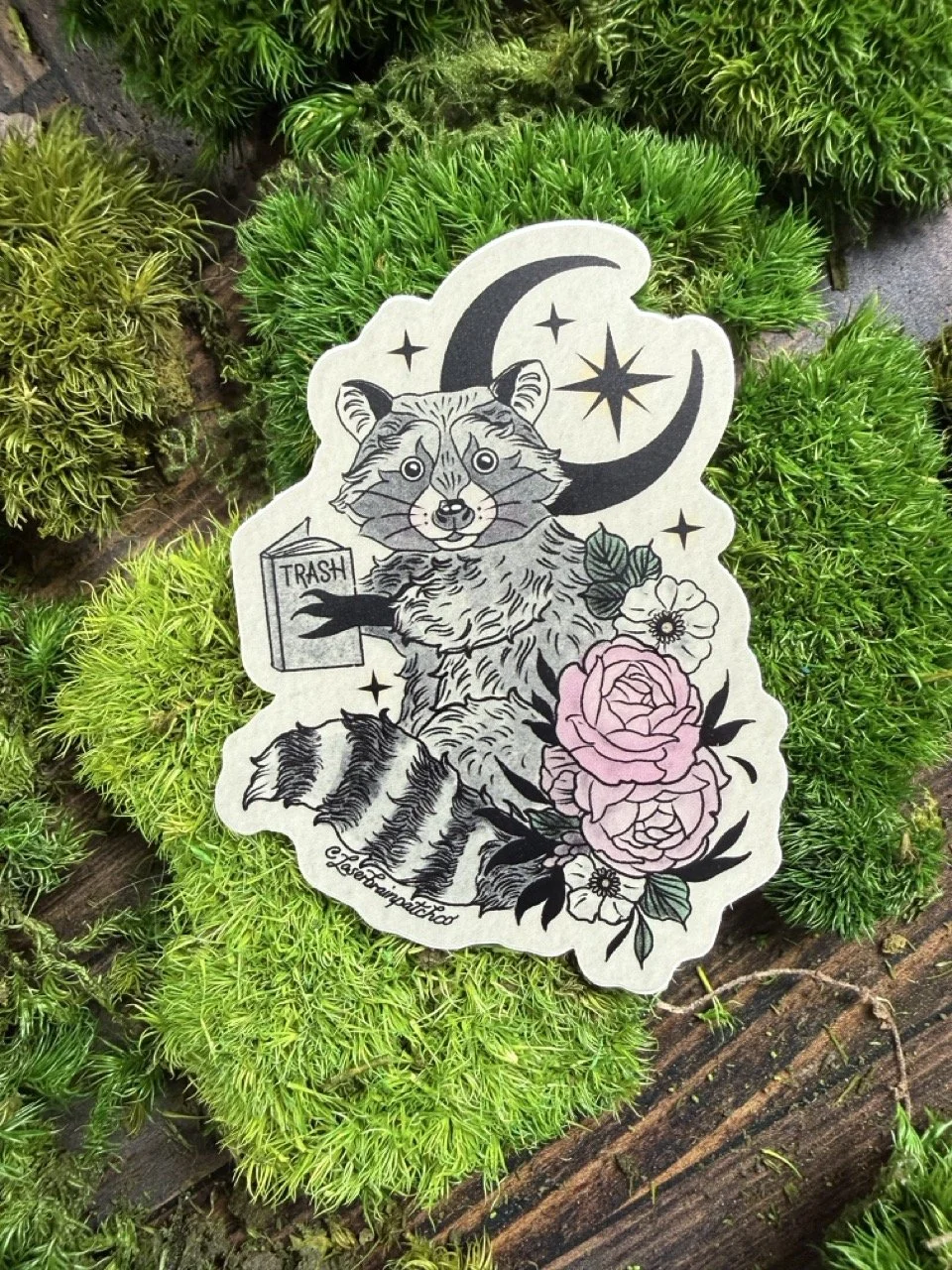 Tan Floral Sitting Trash Reading Raccoon-Sticker