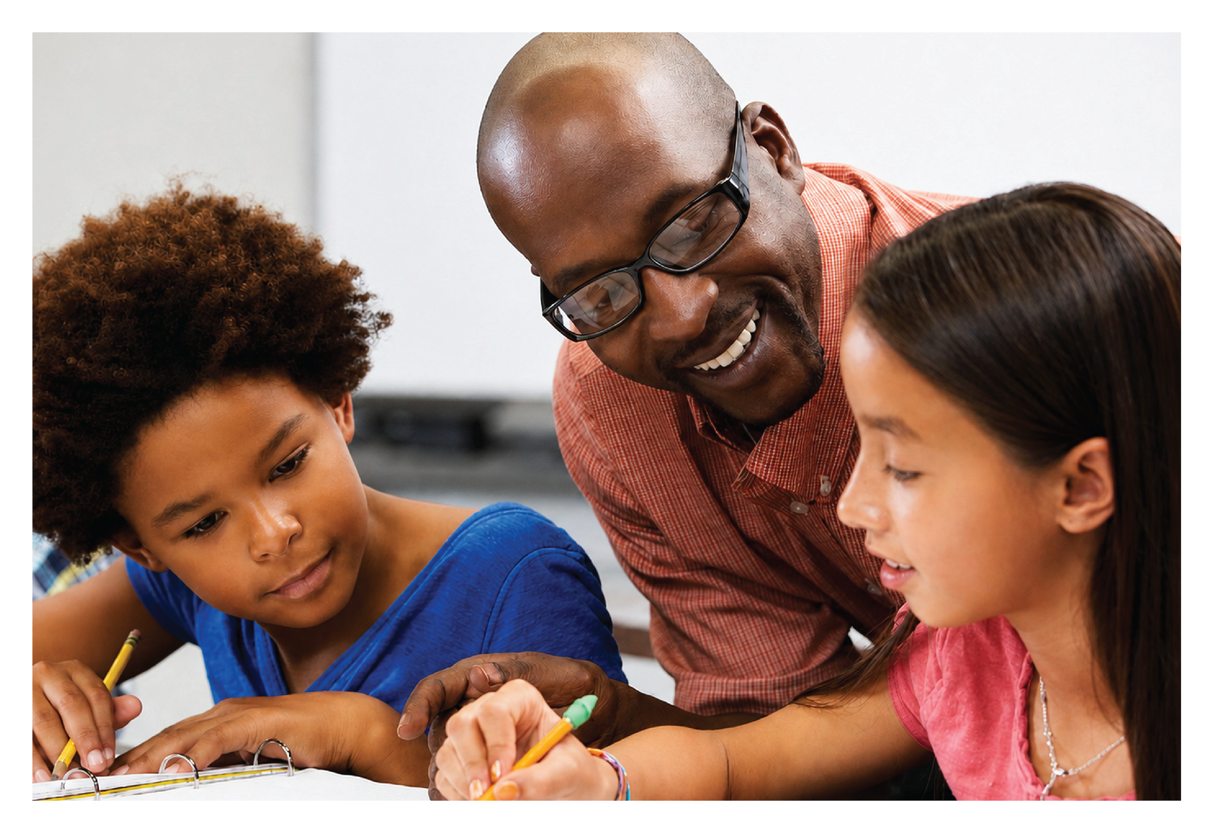 An adult man with glasses and two young girls participating in a shared activity, possibly drawing or writing, in an indoor setting.