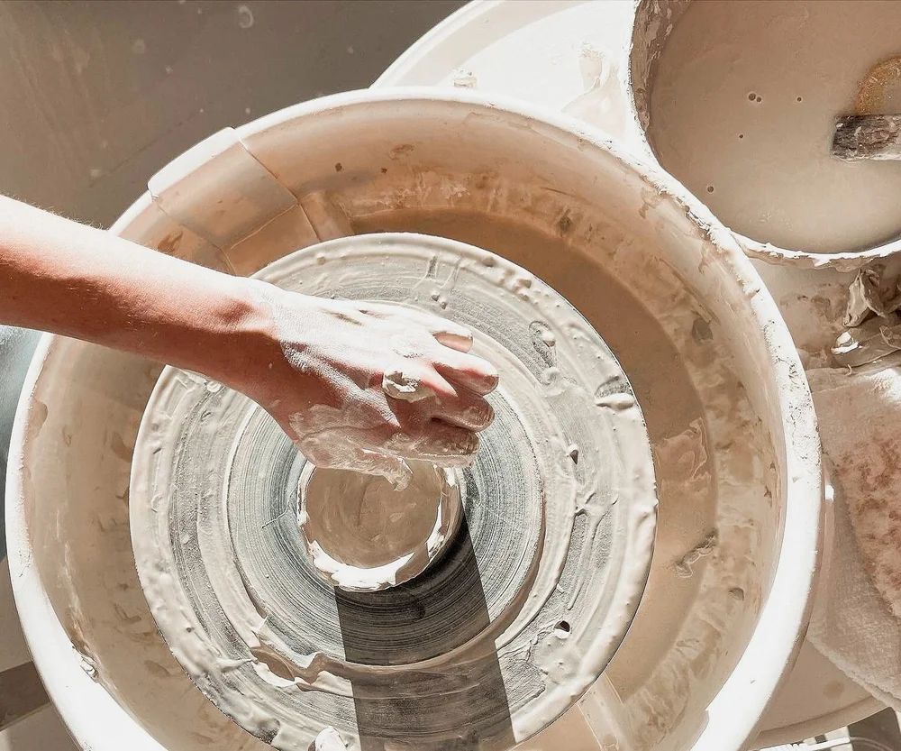 Hands in a bowl on the wheel
