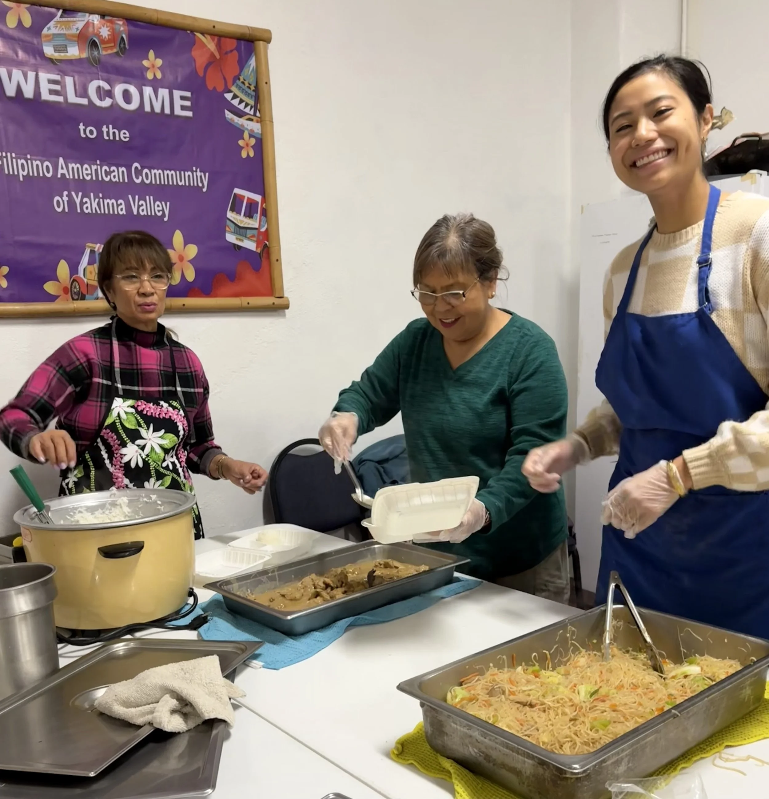 Preciosa Tamaki, Monette Shelton, and Briana Tamaki serve the senior meals 