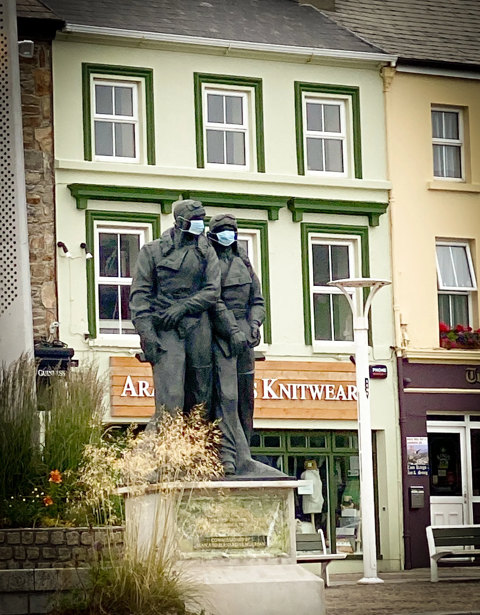 statue in clifden with facemasks