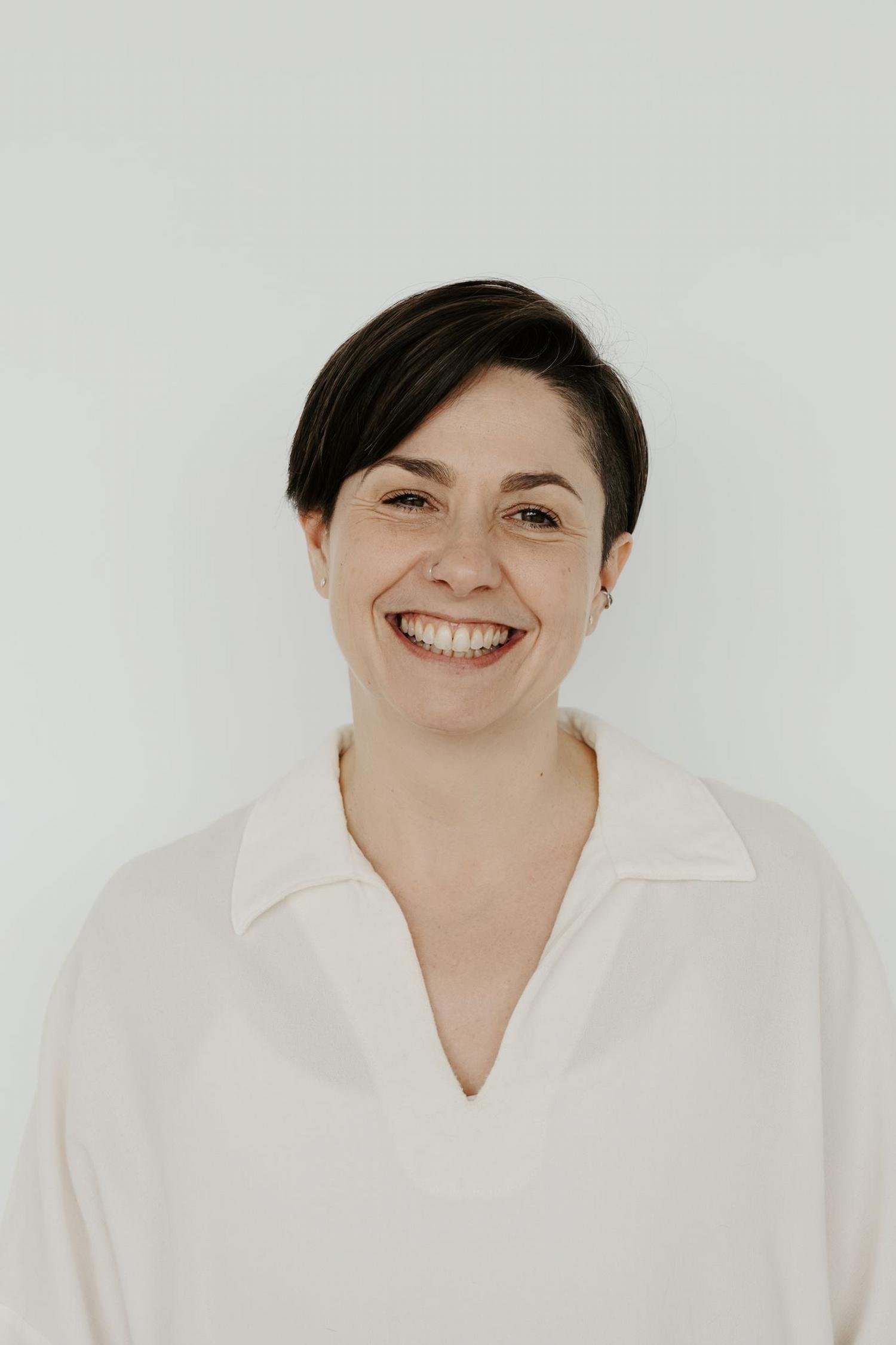 Portrait of Sophie Rowland yoga teacher at Meridian Yoga & Pilates, smiling in the studio
