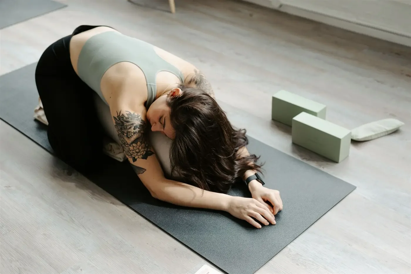 Student in supported child’s pose during a calming Restorative Yoga class at our Glasgow East End yoga and Pilates studio