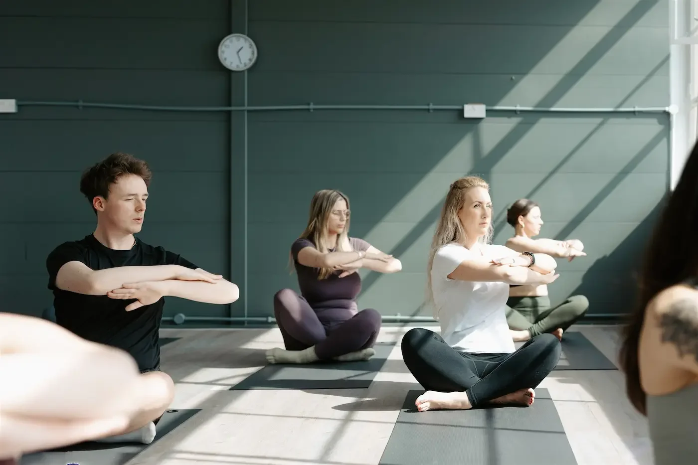 Students practicing Pilates together during a group class at our Glasgow East End yoga and Pilates studio