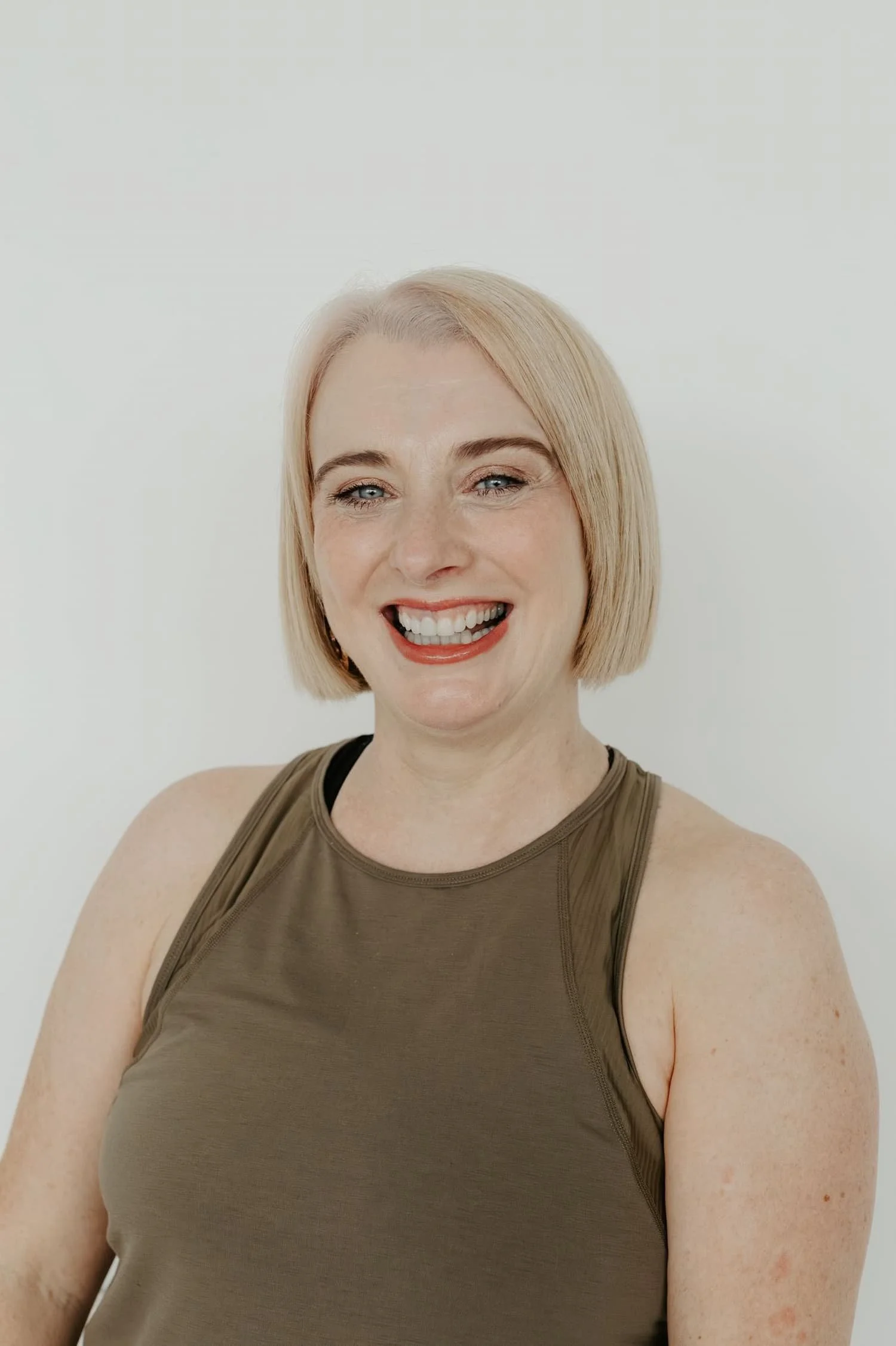Portrait of Michelle Lang, owner and lead teacher at Meridian Yoga & Pilates, smiling outdoors