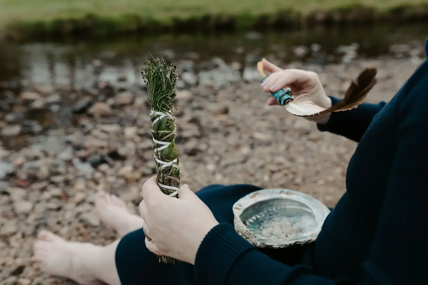 Michelle Lang, Glasgow based Shamanic Practitioner burning sage during an outdoor ceremony