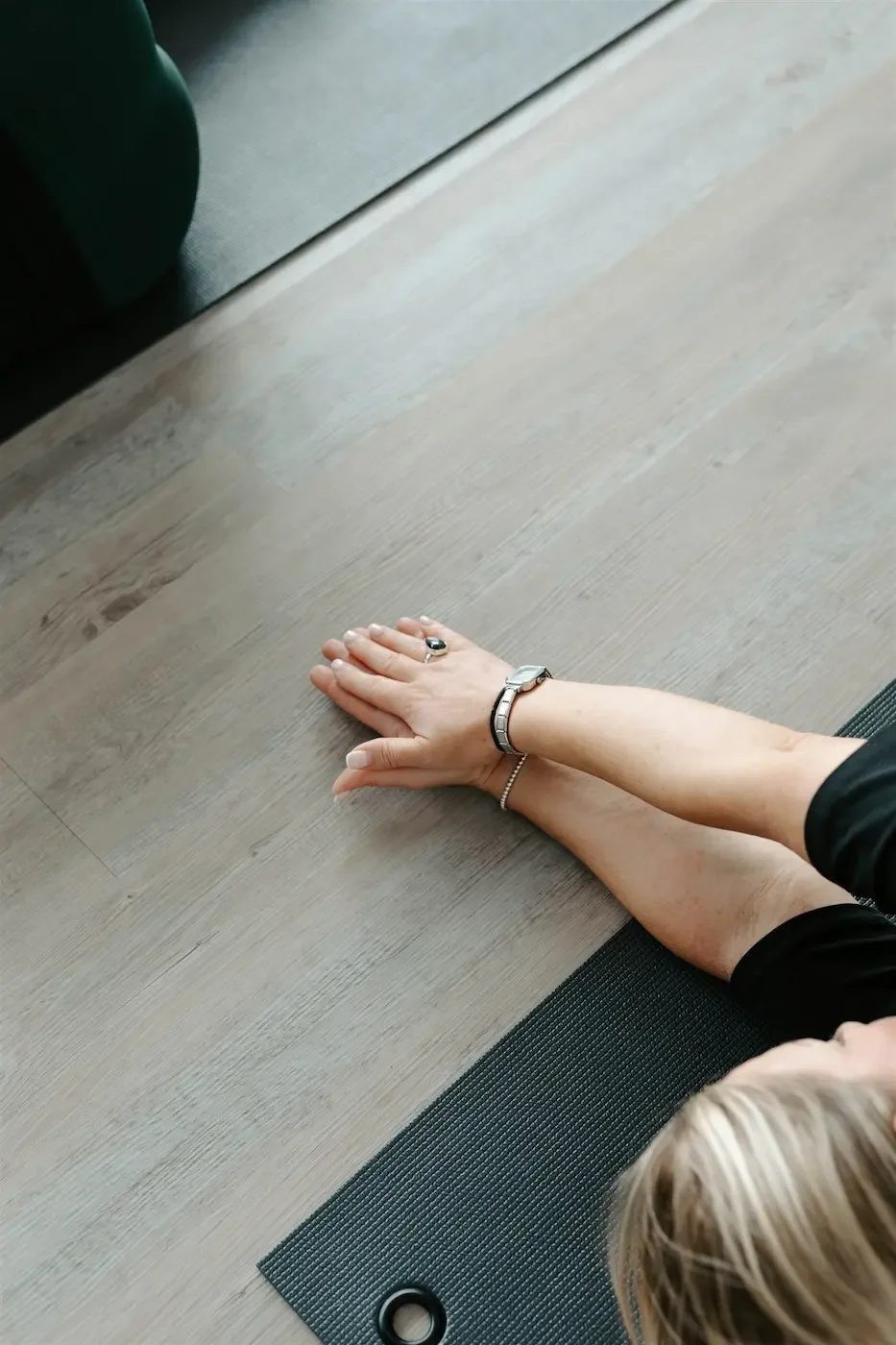 Person gently moving into a supine twist during a private yoga session at our Glasgow East End yoga and Pilates studio