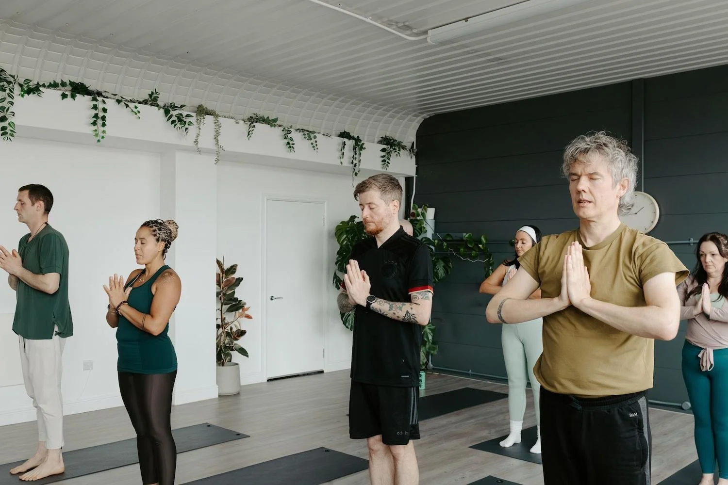 A group standing on their mats at Meridian during our beginners yoga class
