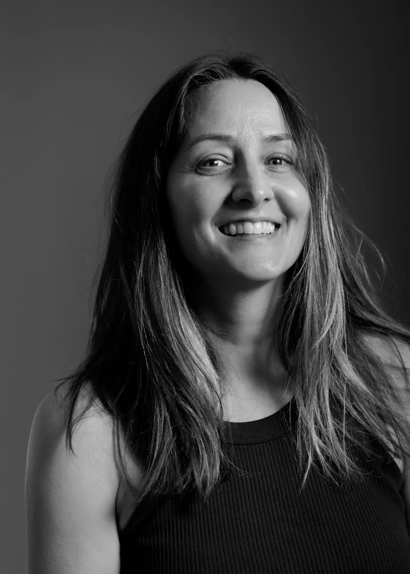 Portrait of Jennifer Donn, Pilates Instructor at Meridian Yoga & Pilates, smiling in the studio