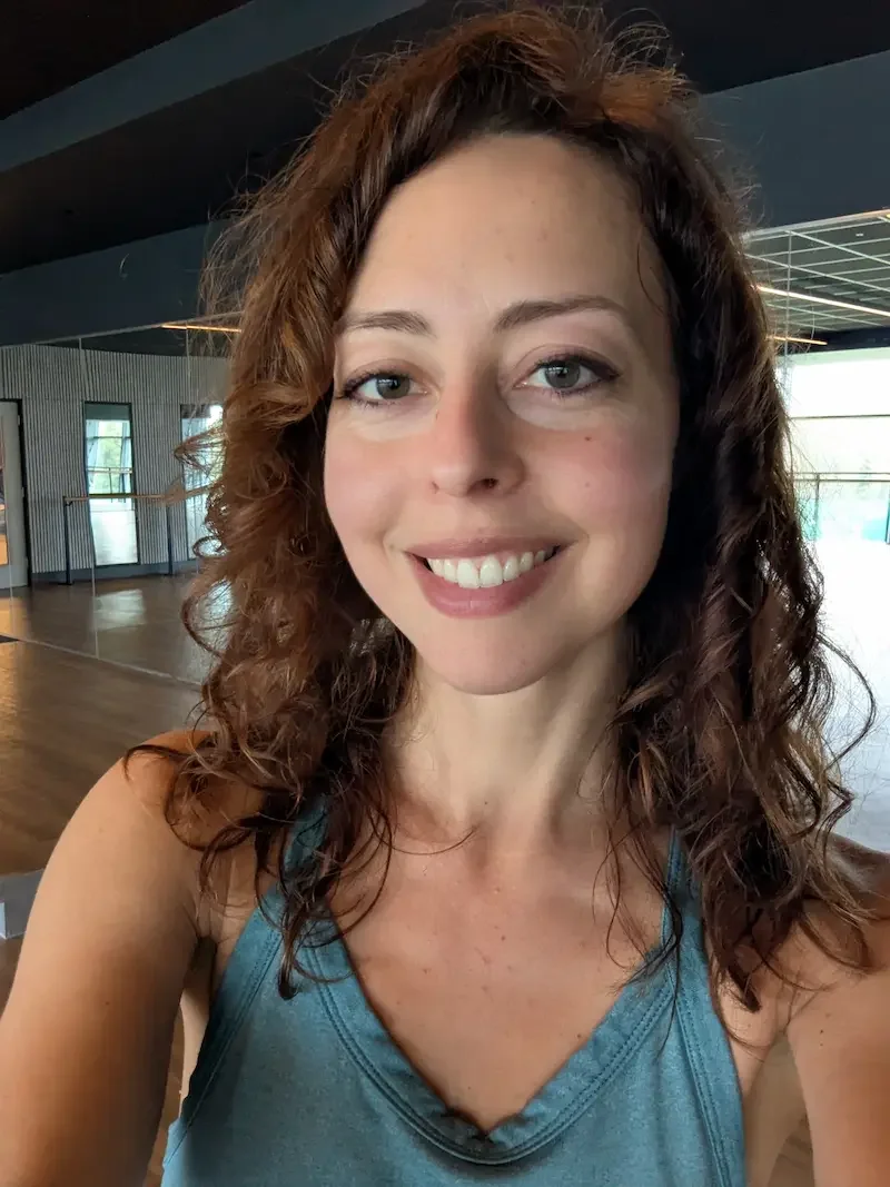 Image of Penny Vlachou, smiling at camera. Penny Vlachou teaches mat pilates and pilates sculpt at Meridian yoga and pilates in the east end of glasgow