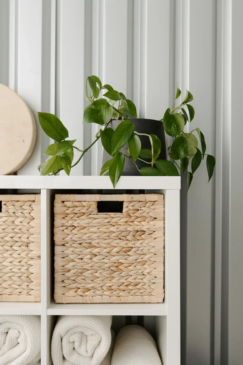 Green plant and a prop shelf with a basket and cream blankets at Meridian Yoga and Pilates studio near Dennistoun, Glasgow East End