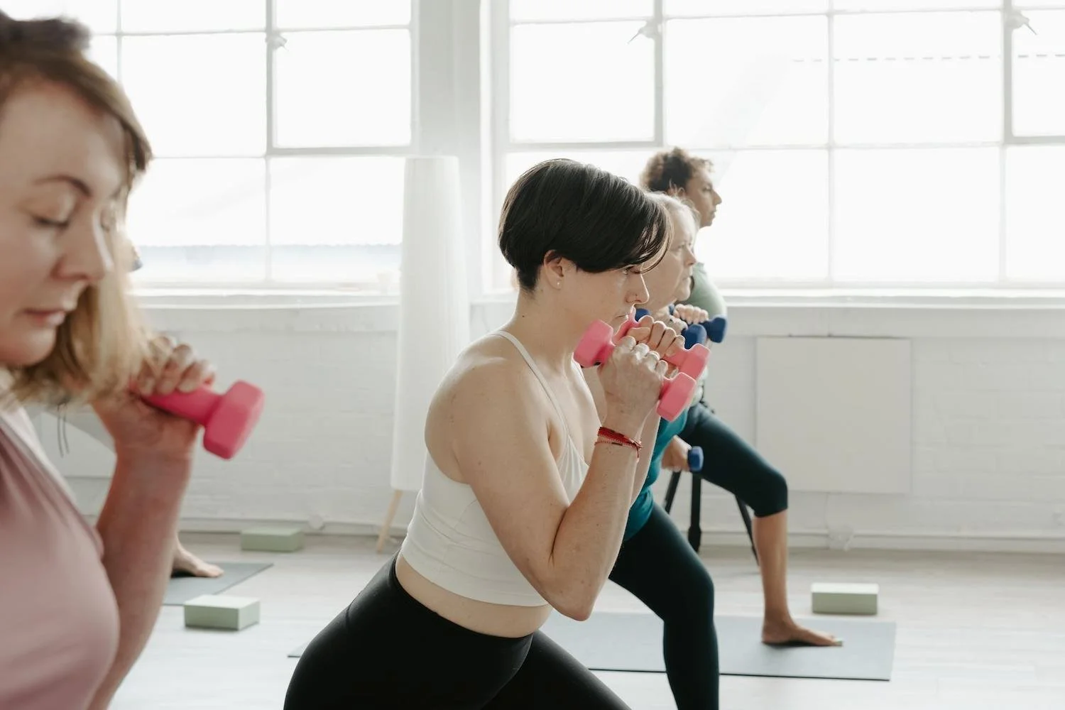 A group using small hand weights at sculpt and flow yoga at Meridian Yoga and Pilates in Glasgow's East End