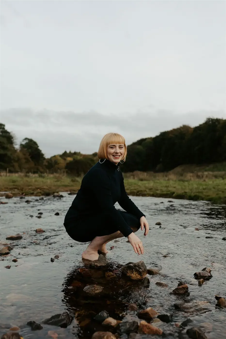 Portrait of Michelle Lang, owner and lead teacher at Meridian Yoga & Pilates, smiling outdoors