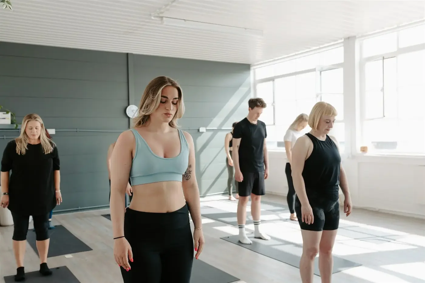 Students practicing yoga together during a 200-hour yoga teacher training at Meridian Yoga and Pilates studio in Glasgow.