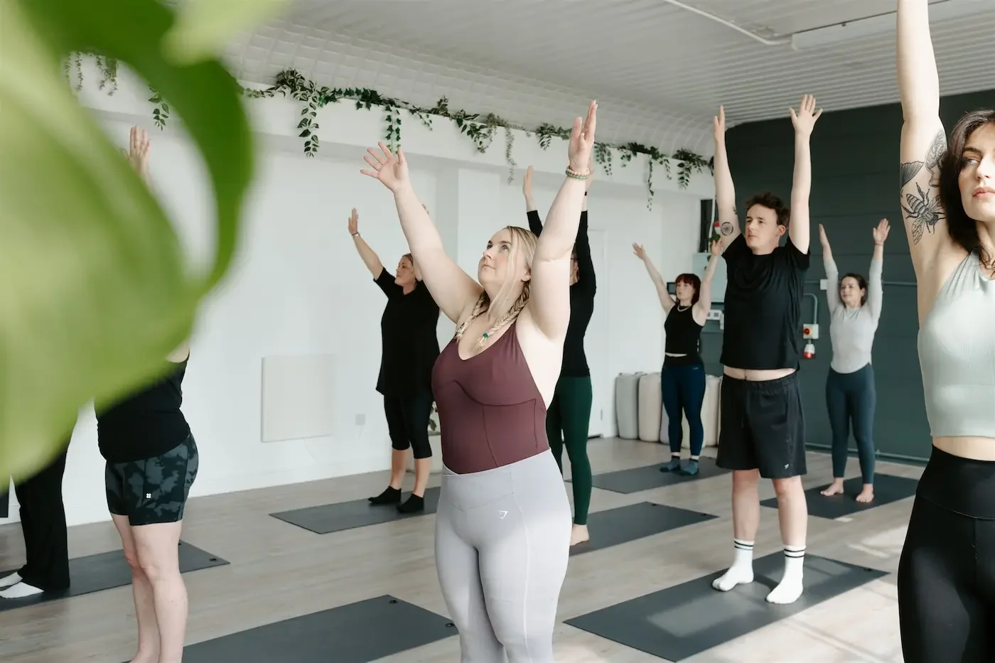 Group practicing sun salutations during the Energise Vinyasa class at Meridian Yoga & Pilates in Glasgow’s East End