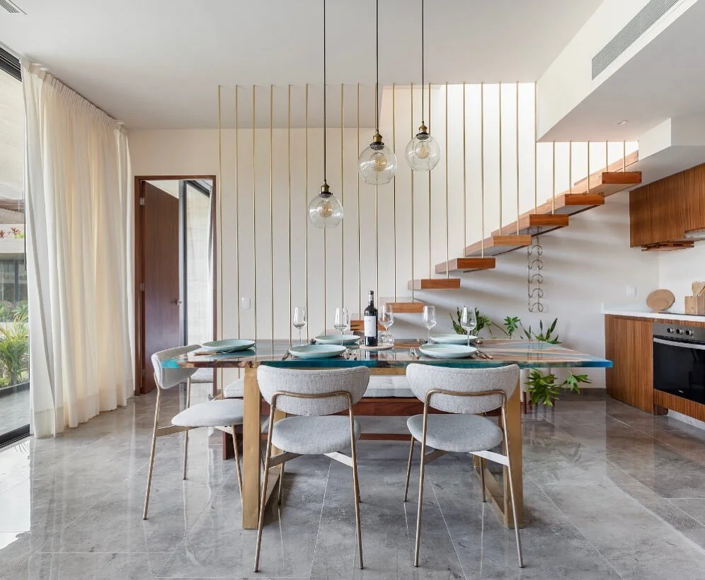 The beautiful dining area from our Mistiq project 🧿 We absolutely love these dining chairs (they match the stairway so well!) but the star of the show is actually the Tzalam wood dining table made with blue acrylic resin. It&rsquo;s one of a kind 