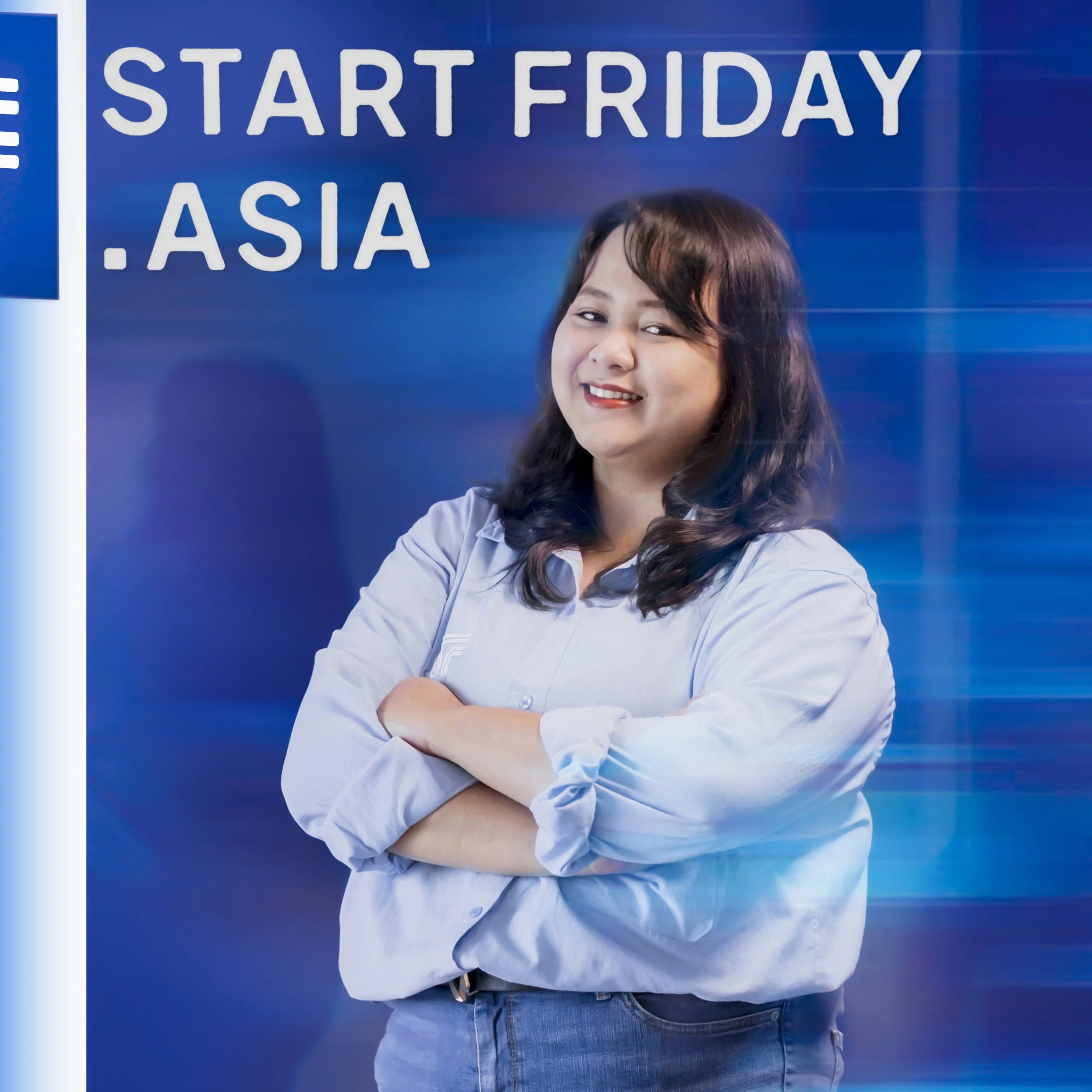 A smiling woman with dark hair, wearing a light blue shirt with rolled-up sleeves and jeans, stands in front of a blue background with text that reads 'Start Friday .Asia'.