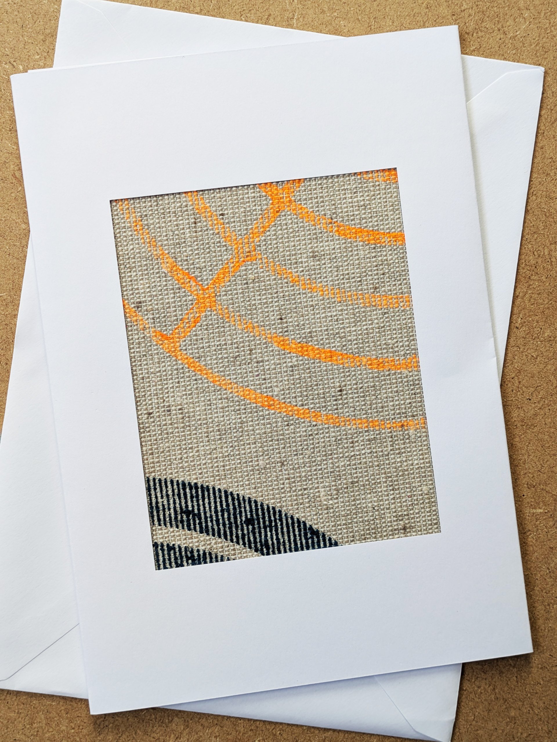 neon circular abstract print on textile framed in white postcard frame and white envelope