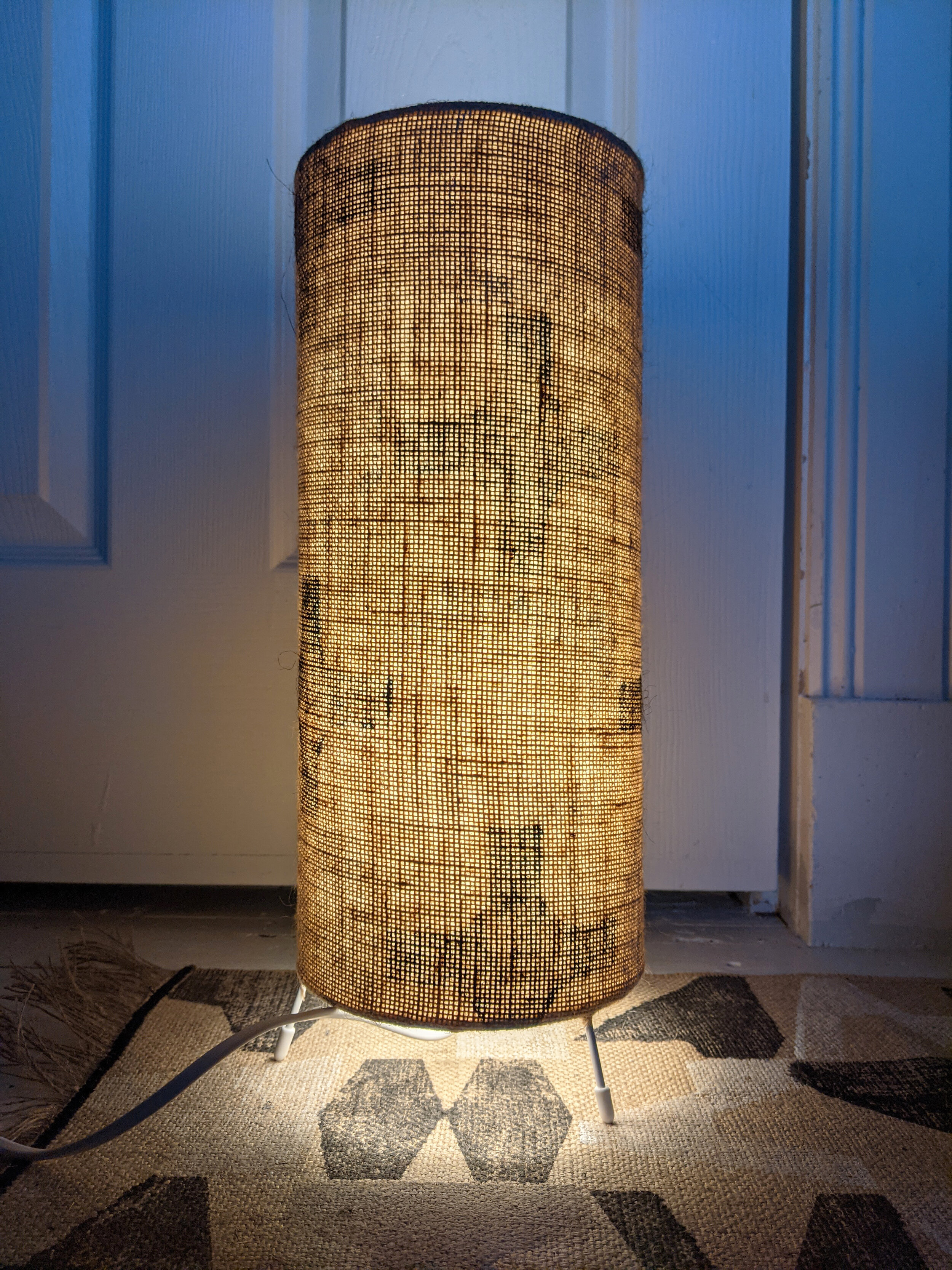 CO-OP small floor lamp with black and white geometric pattern in interior scene with printed jute rug