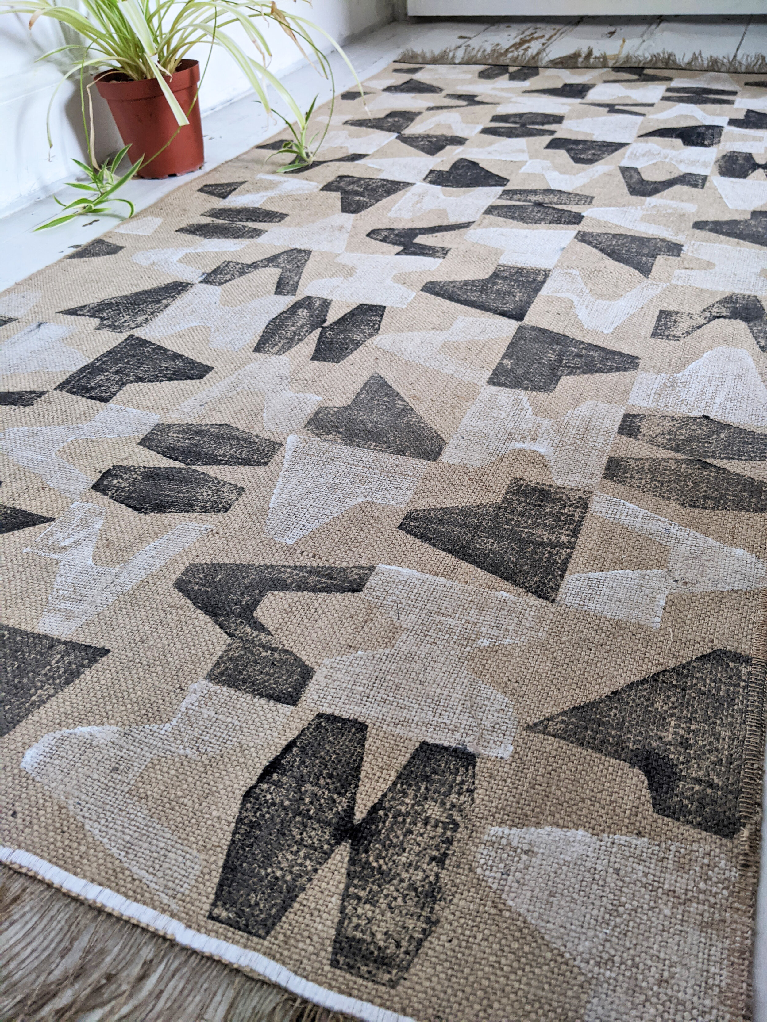 MÁVAUT block printed jute rug with black and white geometric, brutalism inspired pattern
