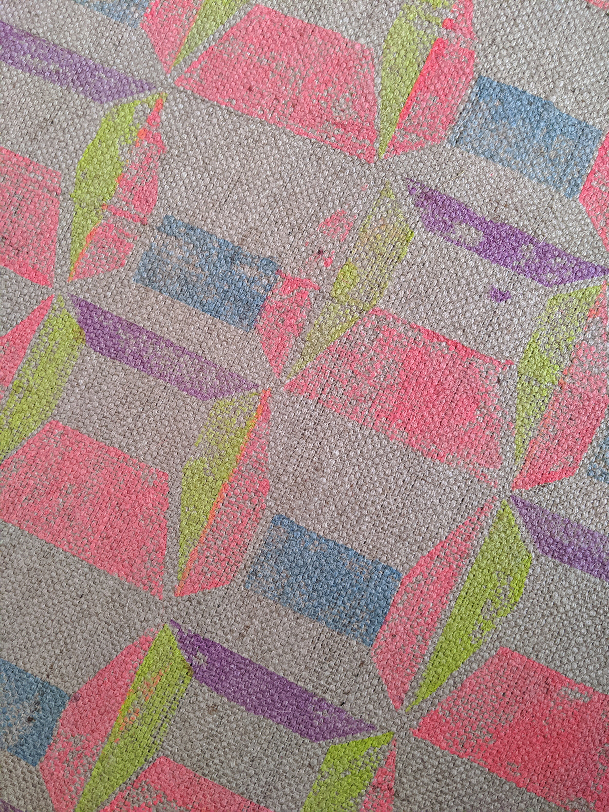 ABLAK block printed rug with geometric pattern in bright red and yellow close-up detail
