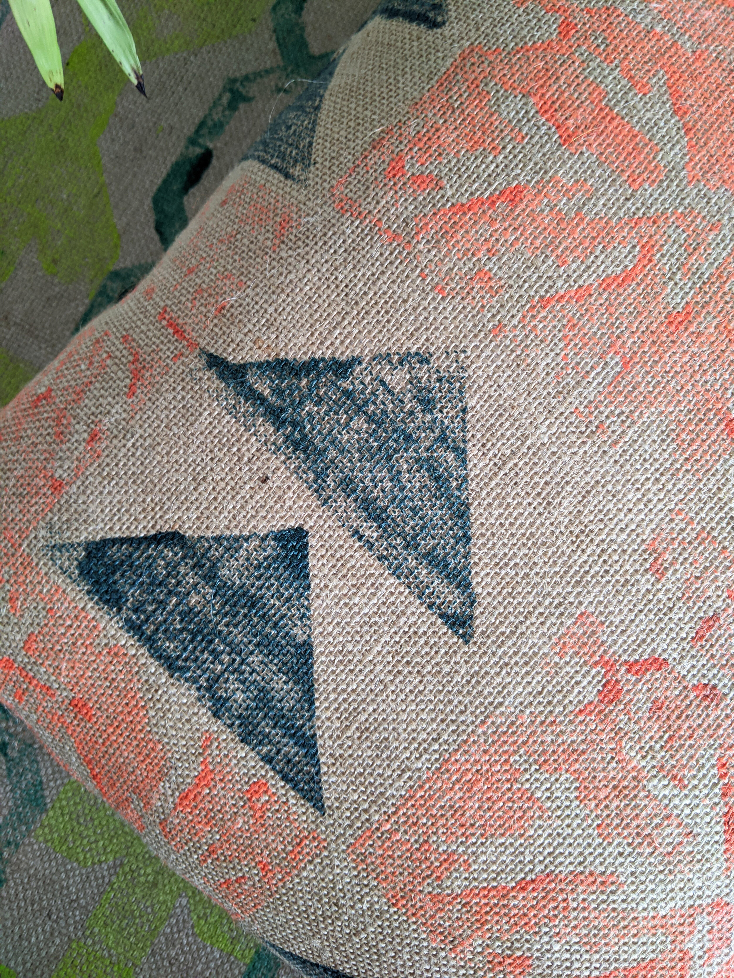 PÁLMAHÁZ neon orange and teal block print jute cushion close-up detail of palm leaf and triangle design