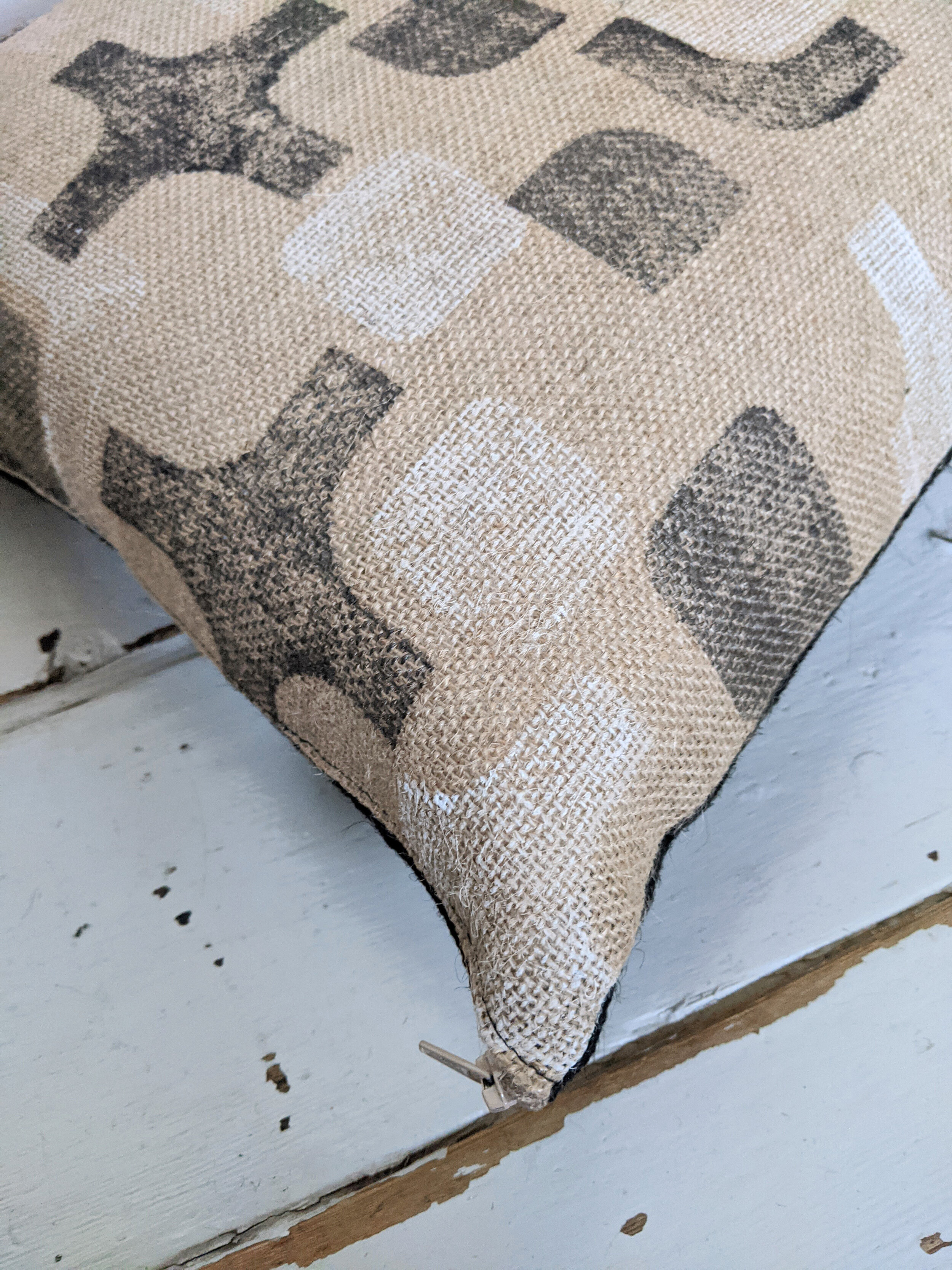 CO-OP detail of black and white geometric random block print on natural jute cushion