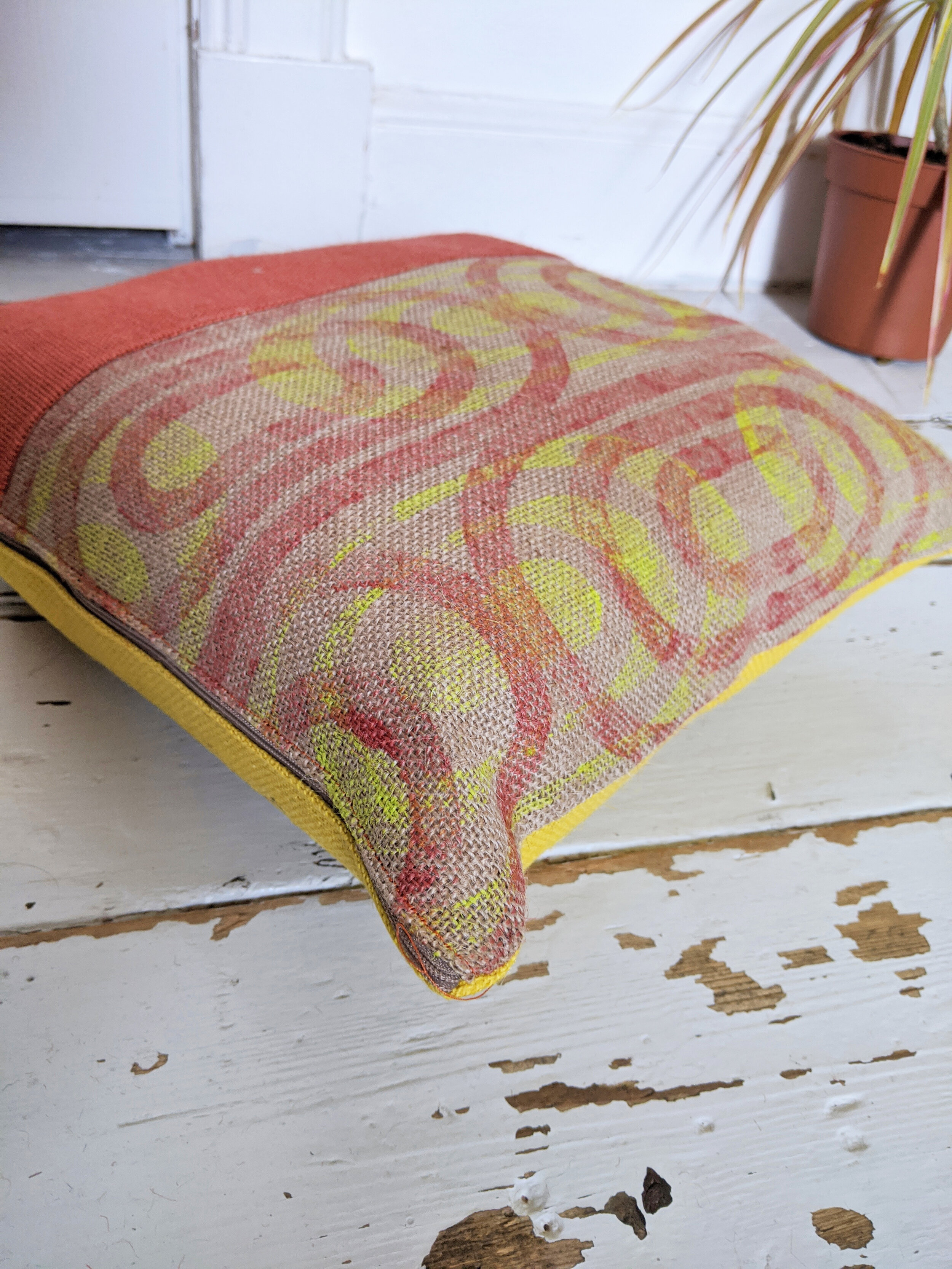 NÉPI cushion with block printed orange 70s inspired retro pattern