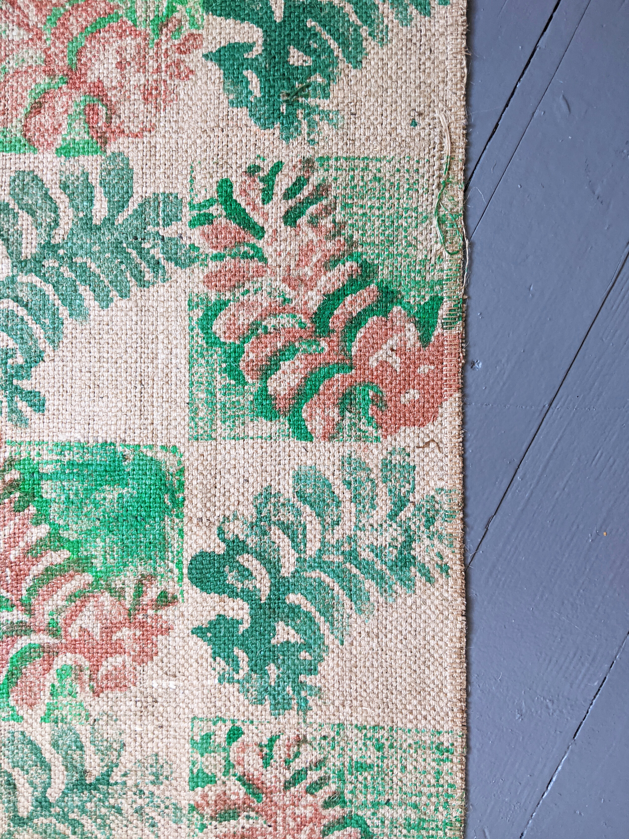 close-up detail of green botanical leaf print on natural jute rug