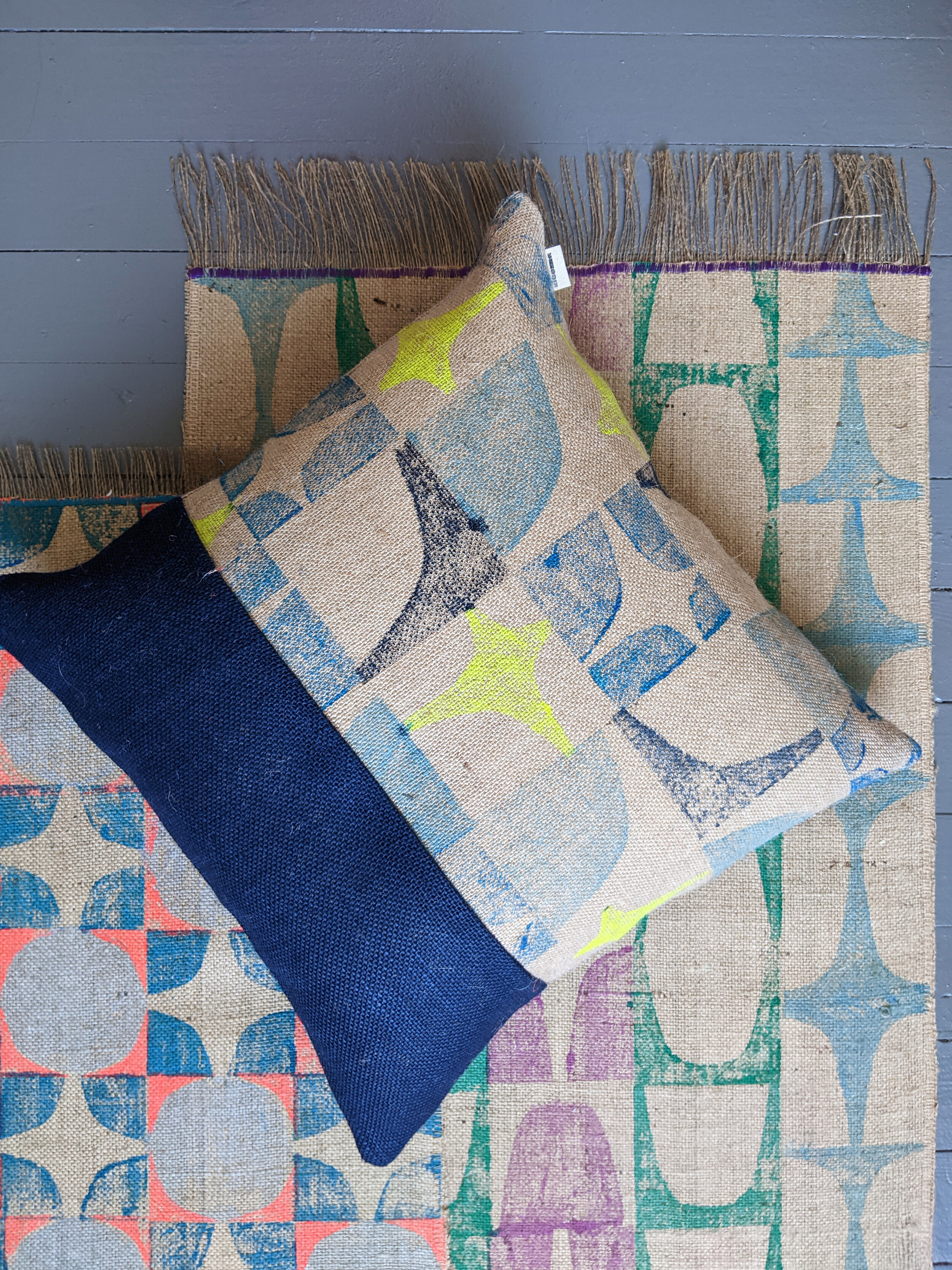 abstract geometric pattern on blue scrap cushion with brutalism inspired block print