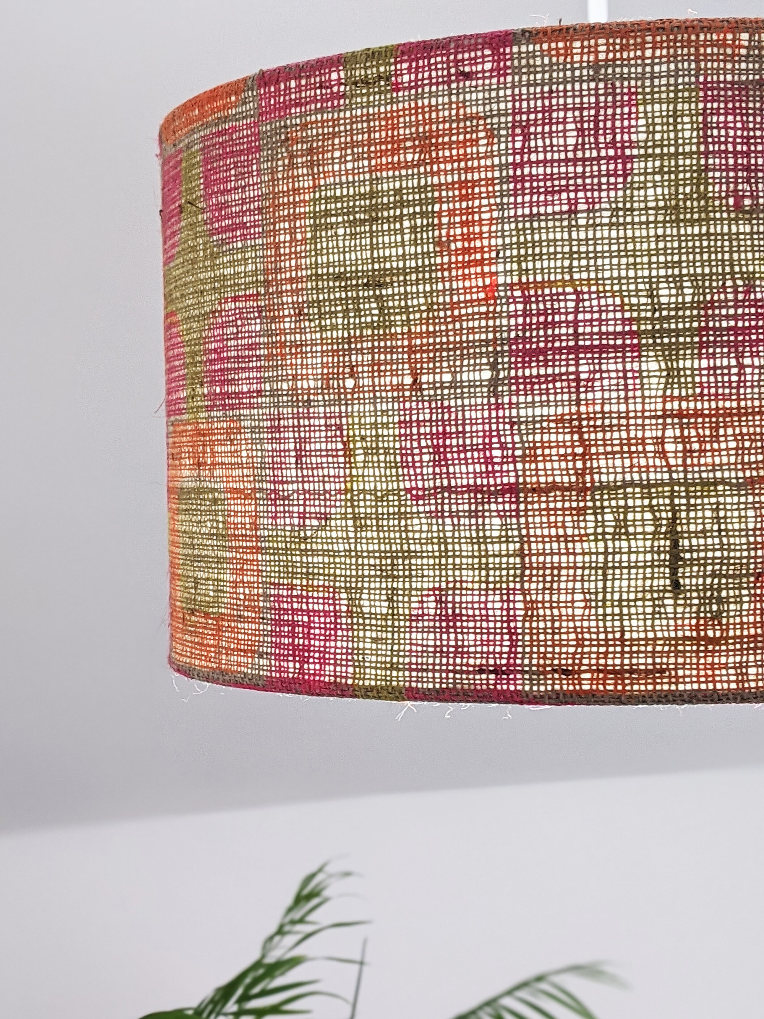 colourful bright geometric pattern on natural sustainable hessian lampshade illuminated