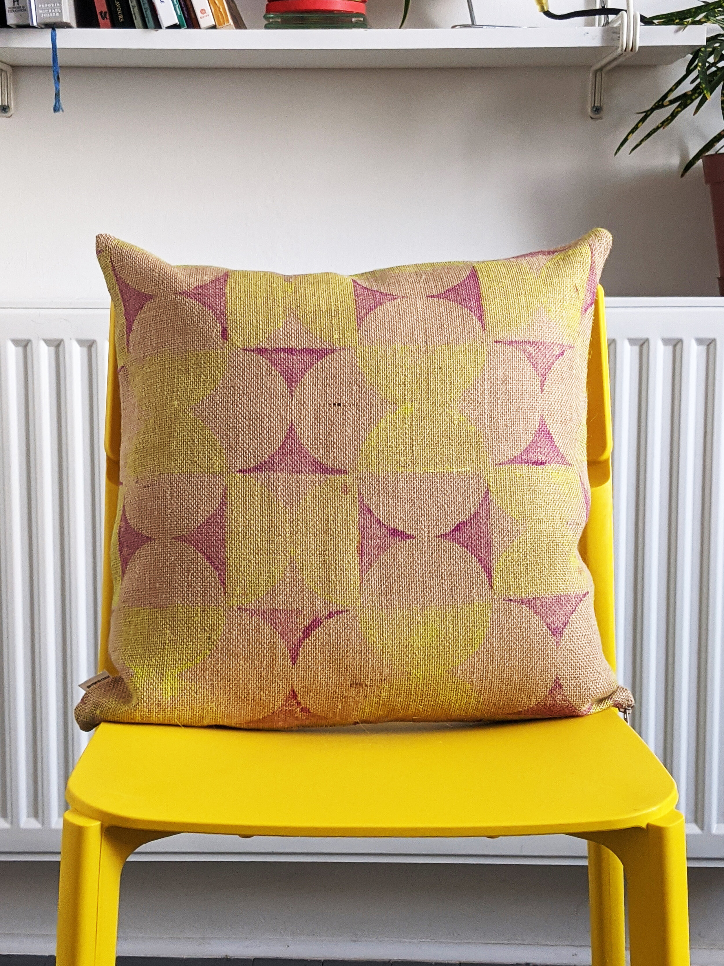 geometric printed jute cushion on yellow chair