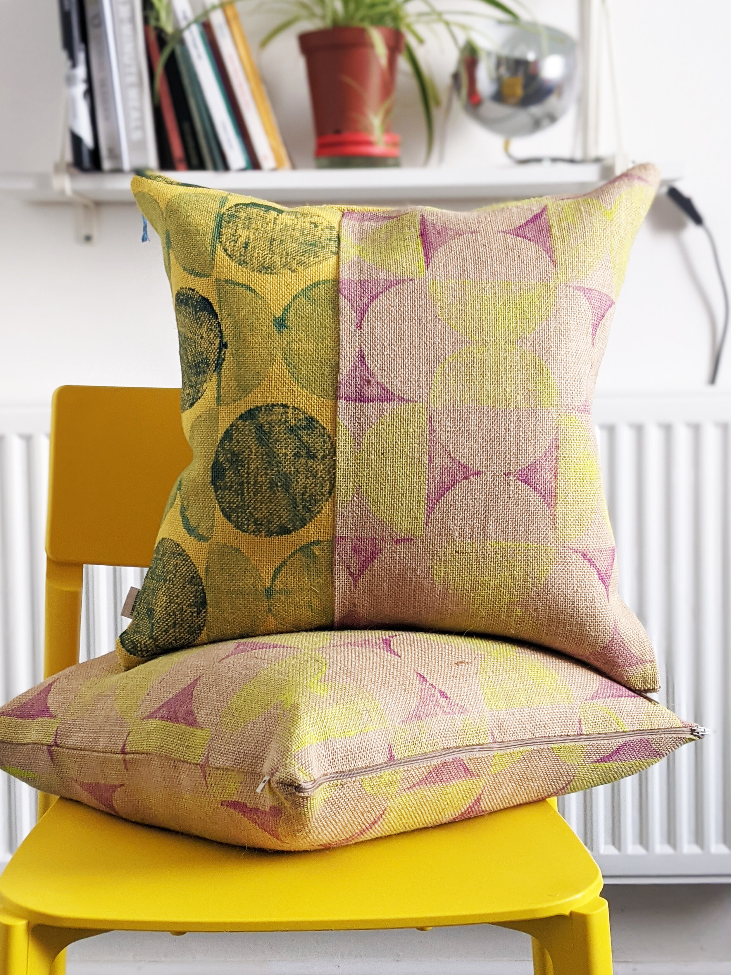 interior decor scene with yellow chair and cushions in modern abstract geometric print