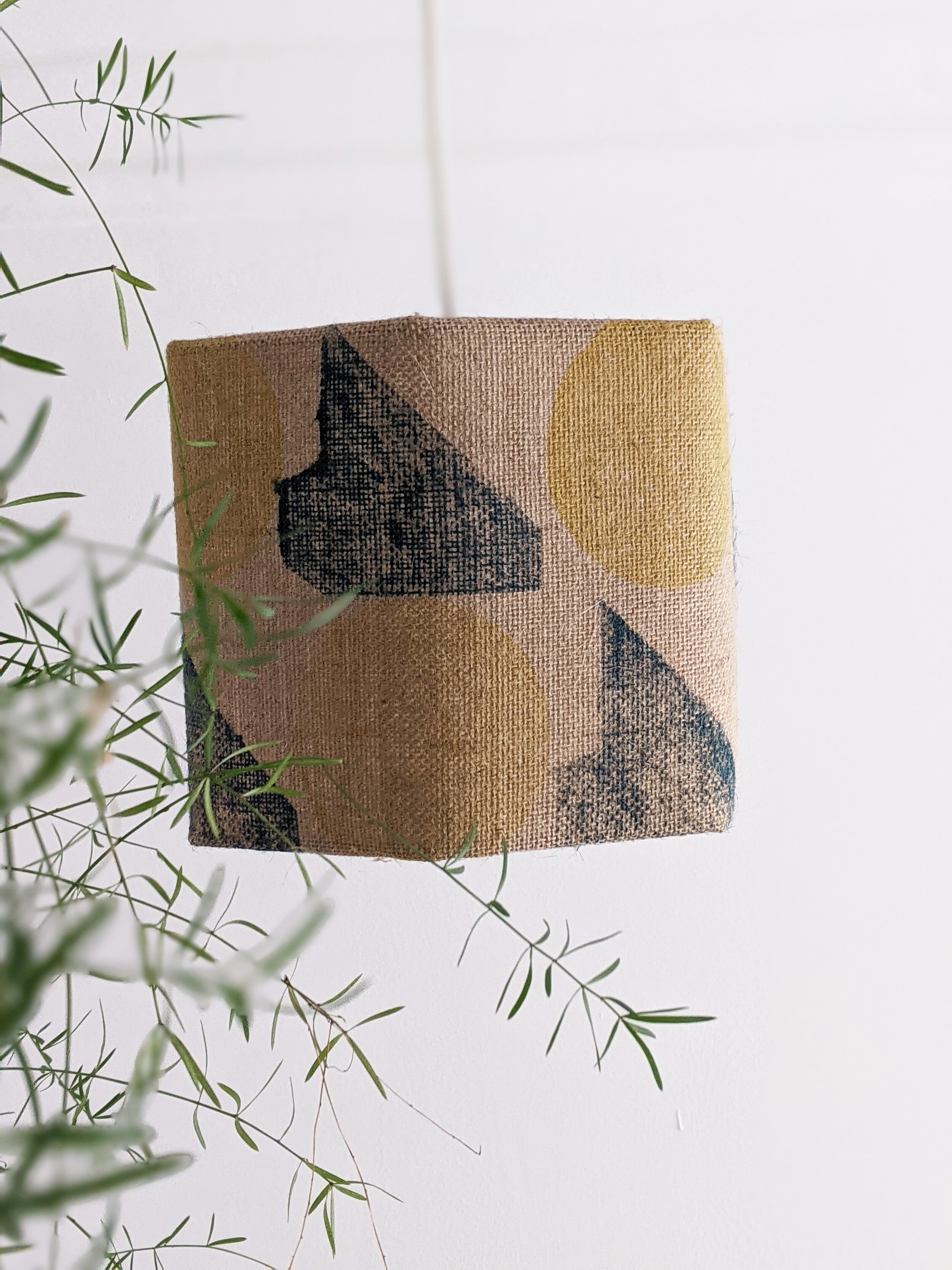 geometric print in teal and yellow on hexagonal lampshade