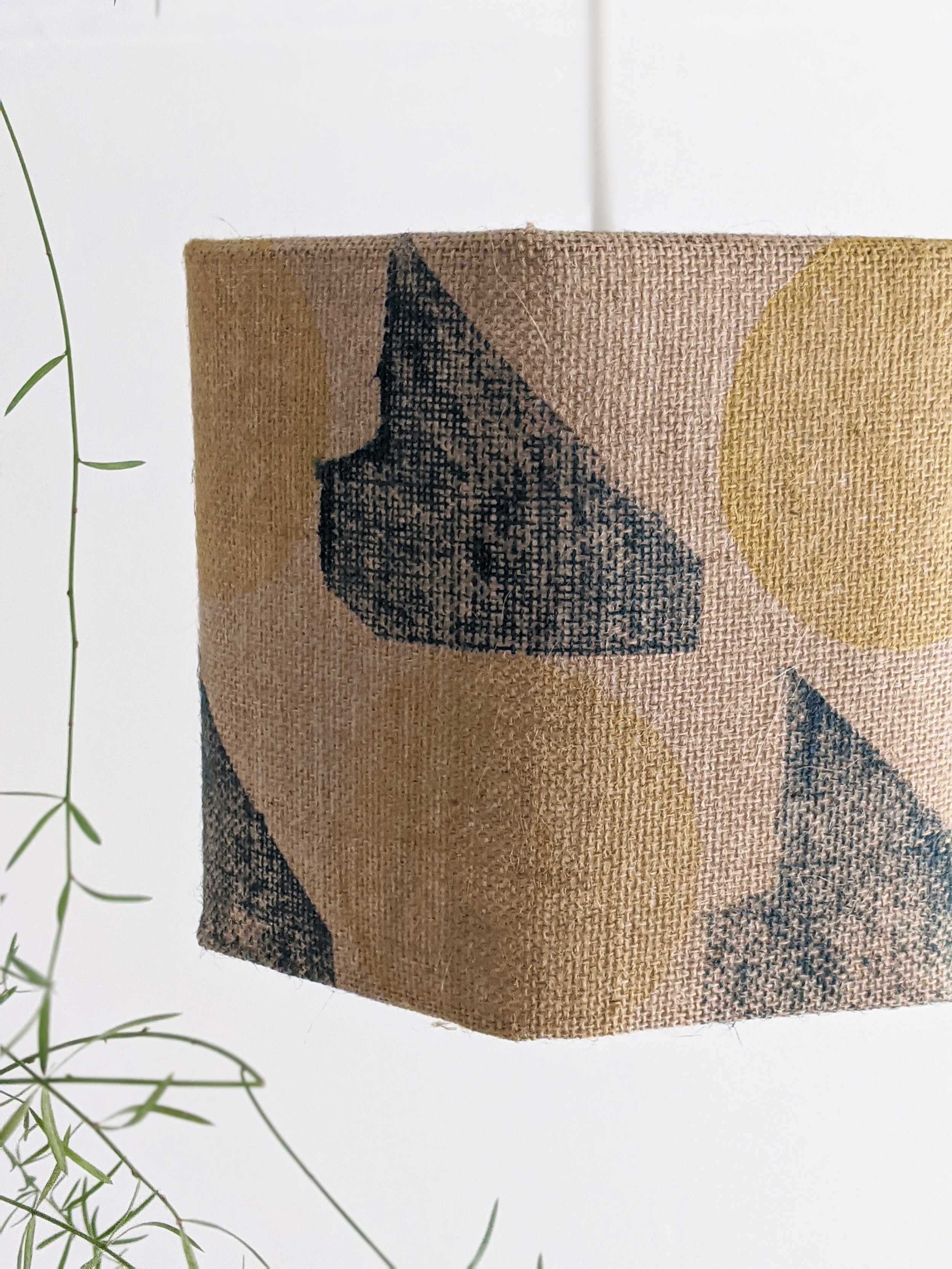 hexagonal lampshade with geometric print in teal and yellow colours