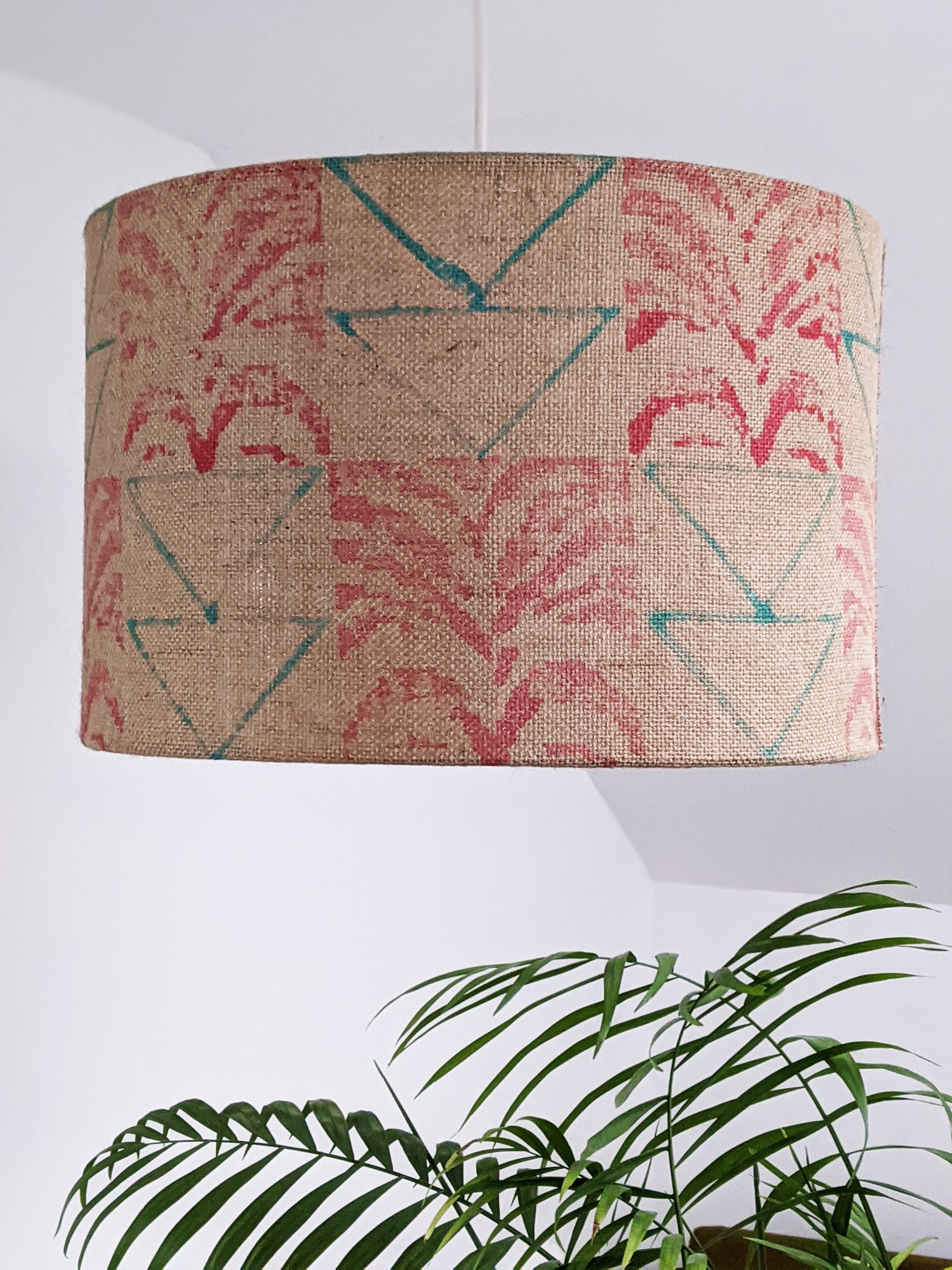 room with houseplant and natural palm print lampshade