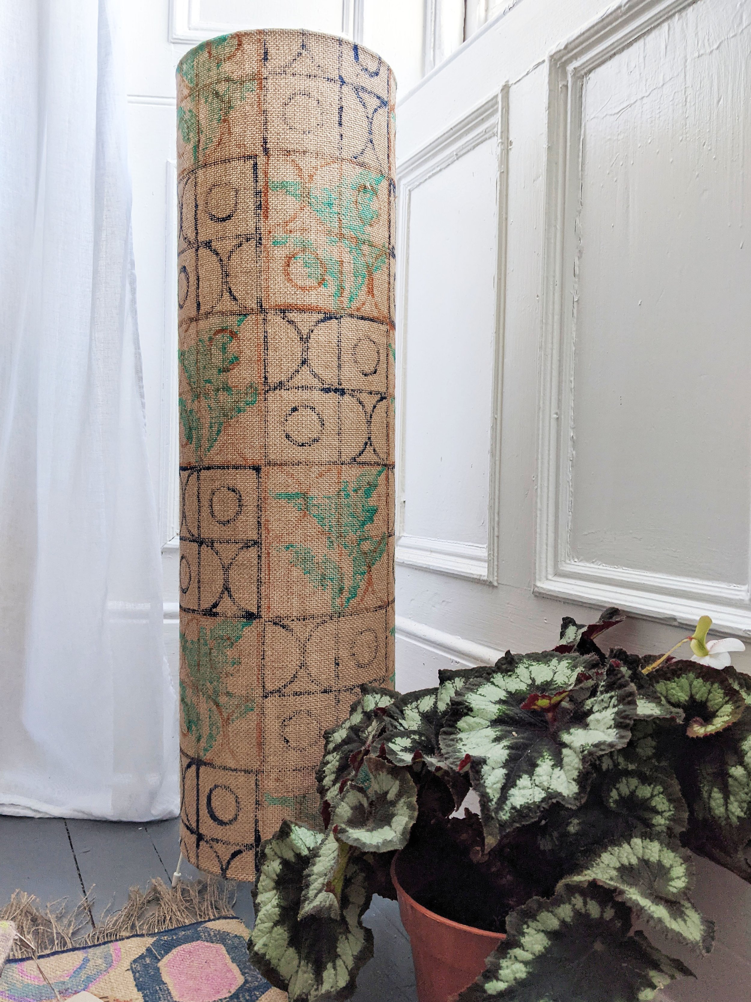 standing jute floor lamp with rustic hand printed pattern in bay window