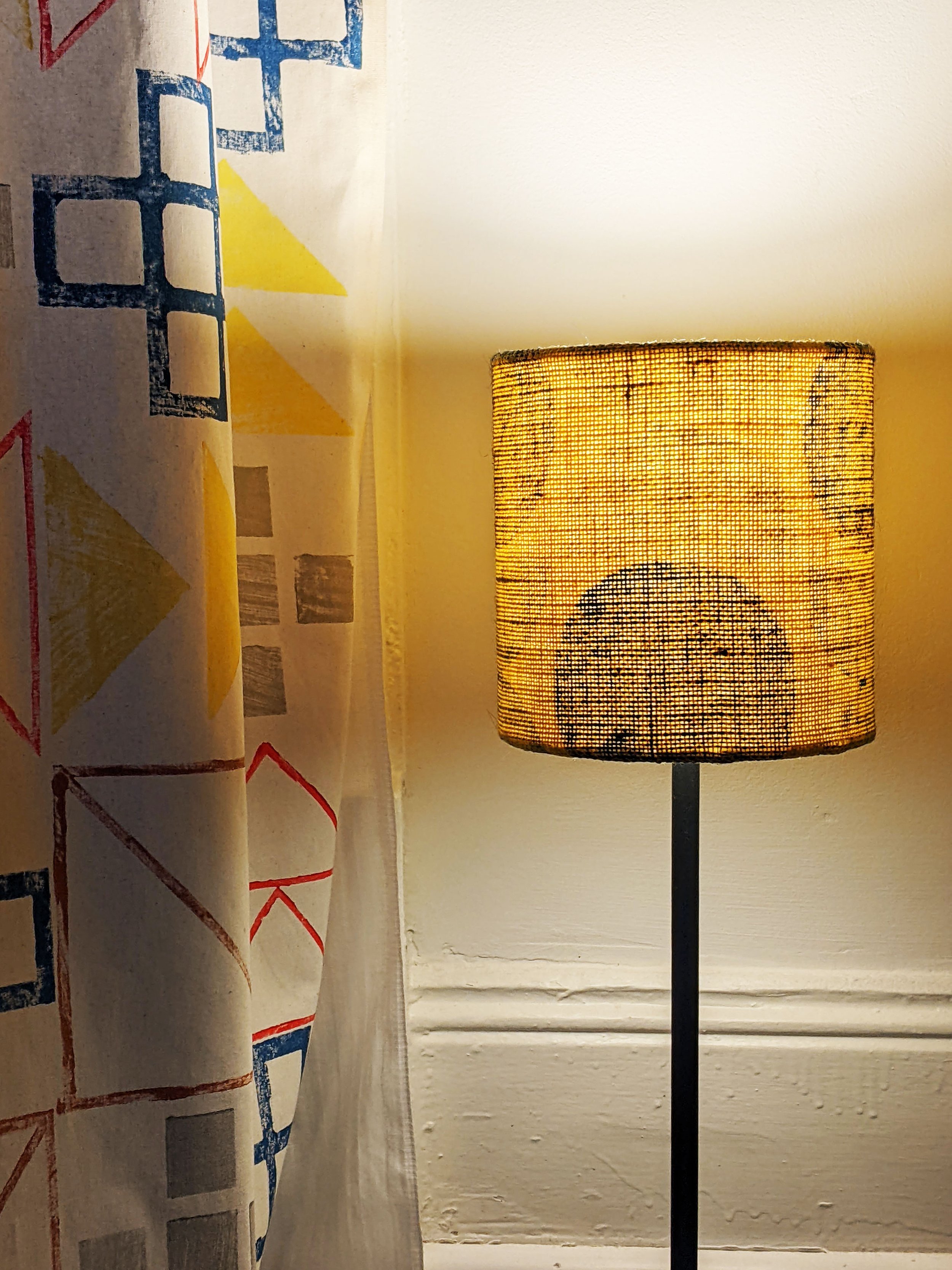illuminated small yellow lamp with circular modern geometric print