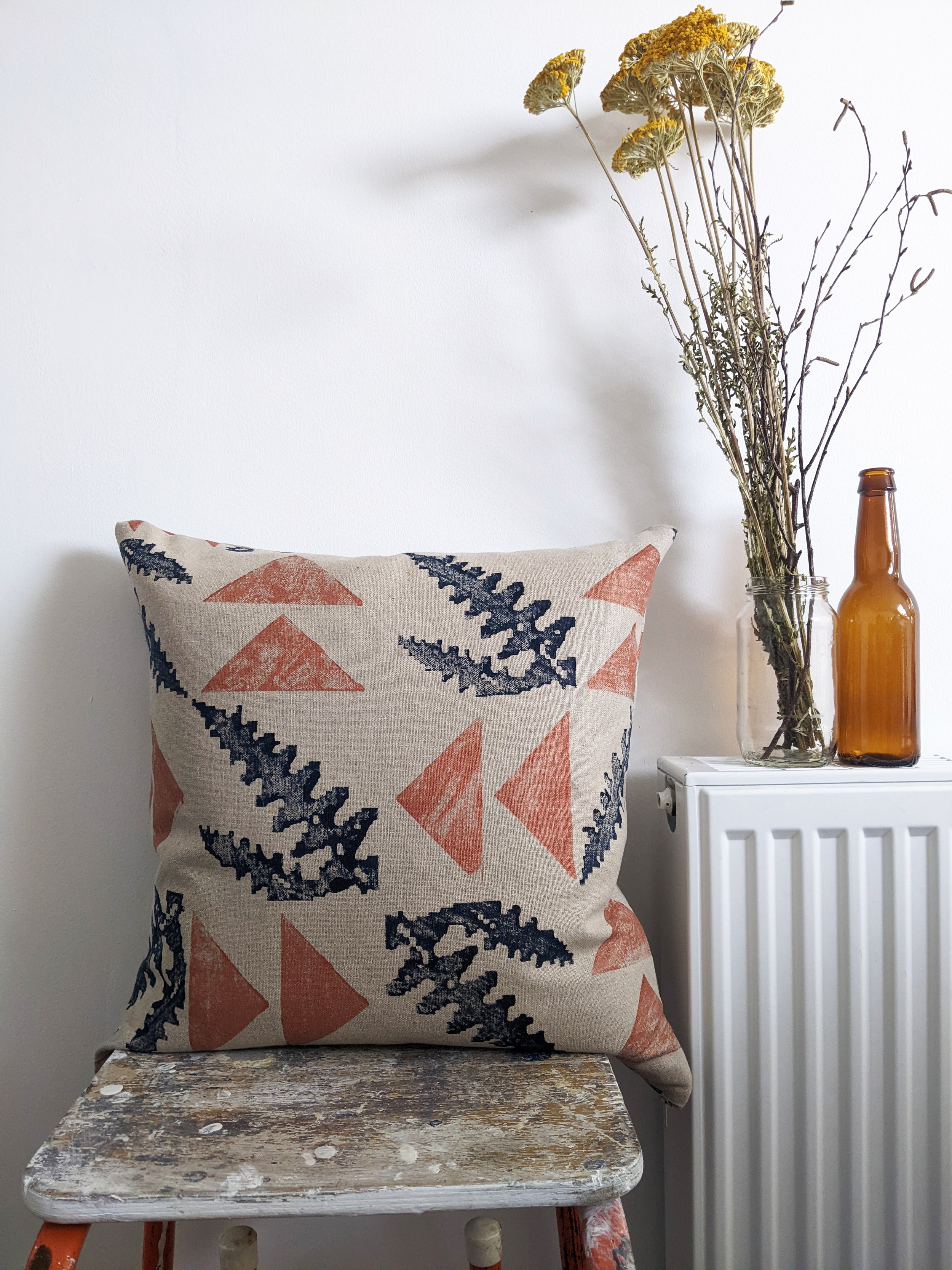 natural linen cushion in modern rustic interior with flowers and leaf print in earth tones