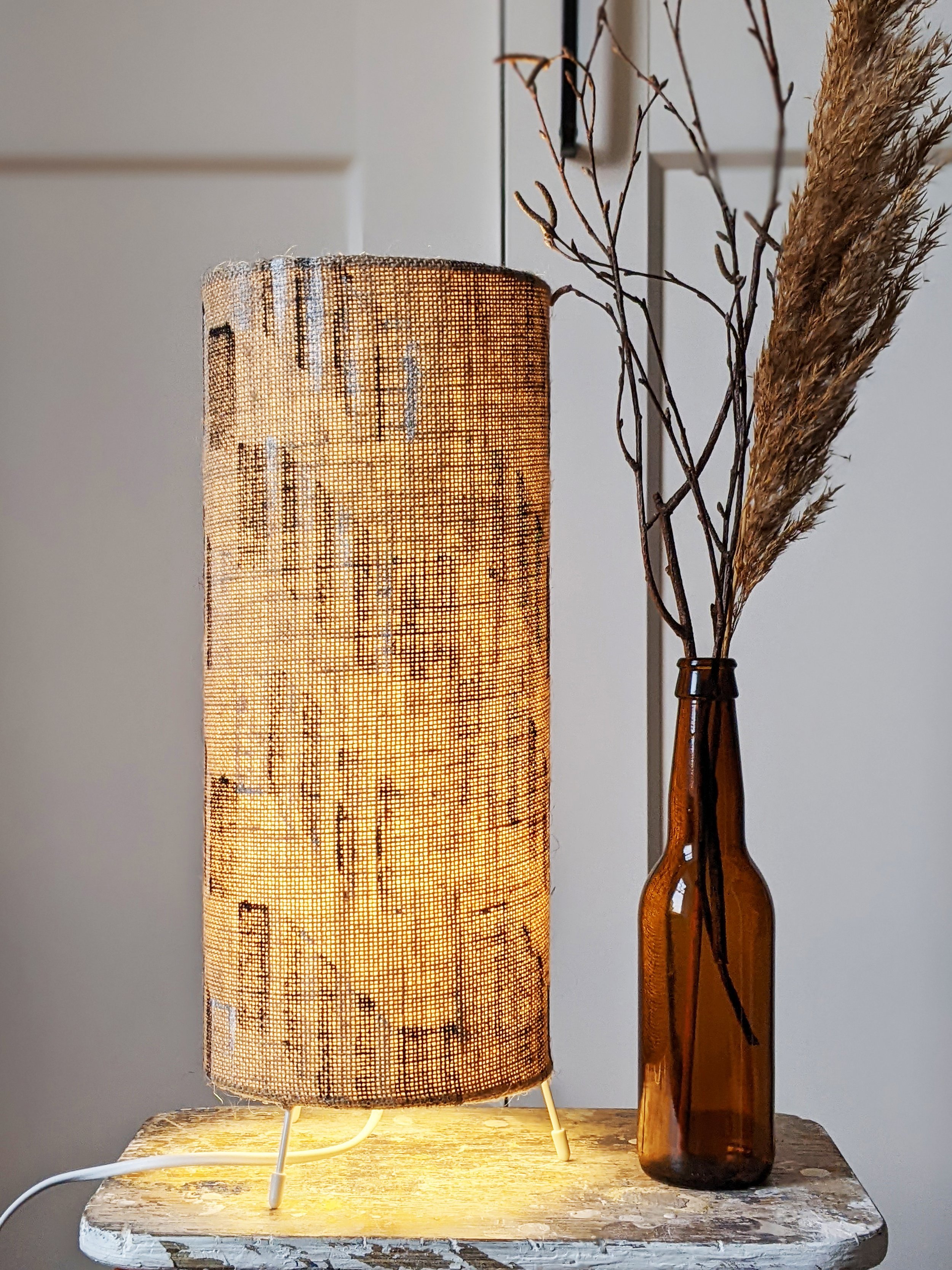 rustic interior decor scene with illuminated natural jute lamp with brutalist architectural pattern